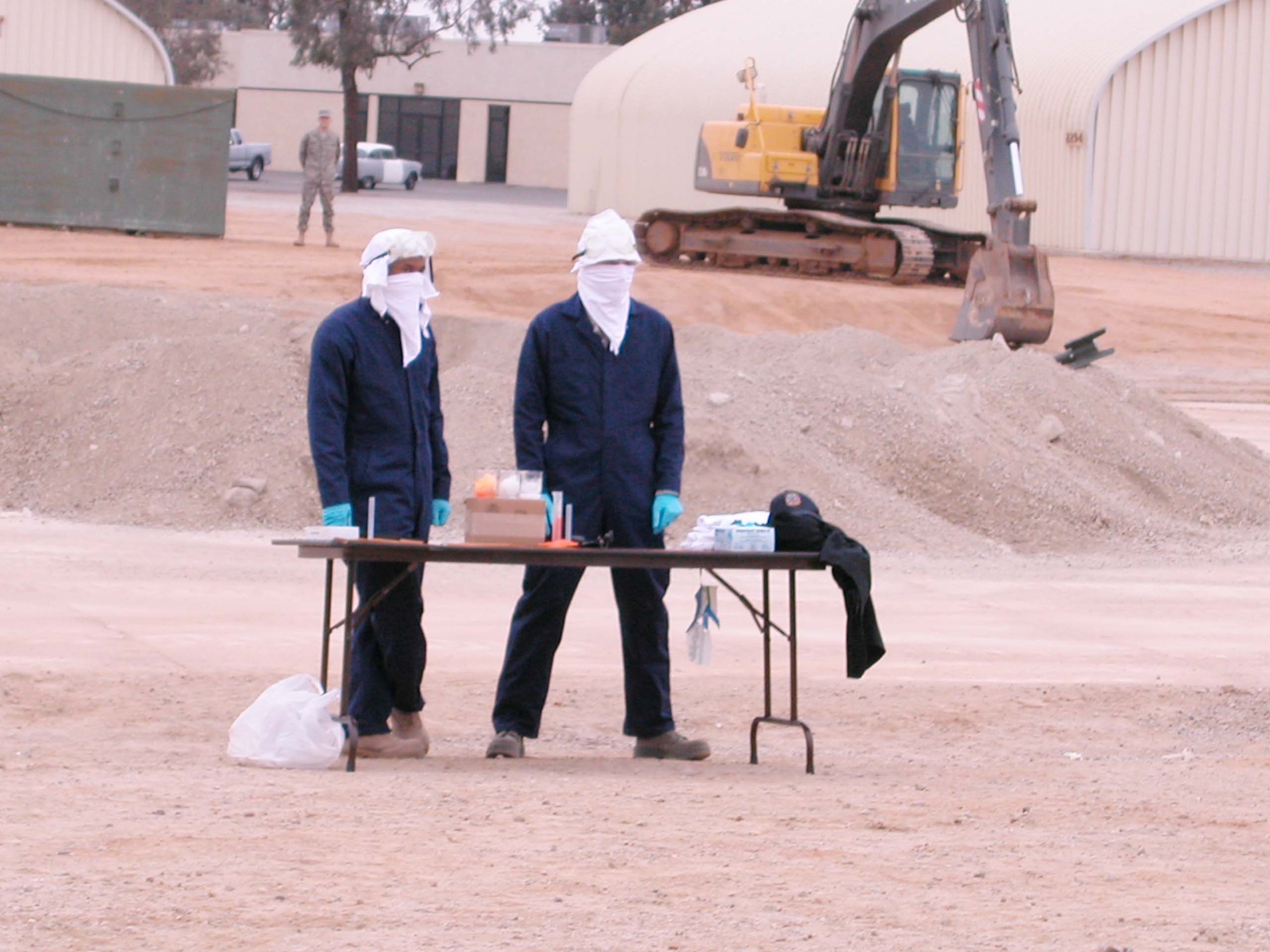 A couple of “terrorists” operate a chemical lab during the biannual Power Demonstration conducted Dec. 13 by the four flights of the 452nd Civil Engineer Squadron at March Air Reserve Base, Calif. After hearing a siren, they quickly ran off, leaving evidence behind for Emergency Management personnel to sort through and identify.  The purpose of the demonstration was to show family and base members the squadron's wartime capabilities. (U.S. Air Force photo by Senior Airman Kara McGrath)