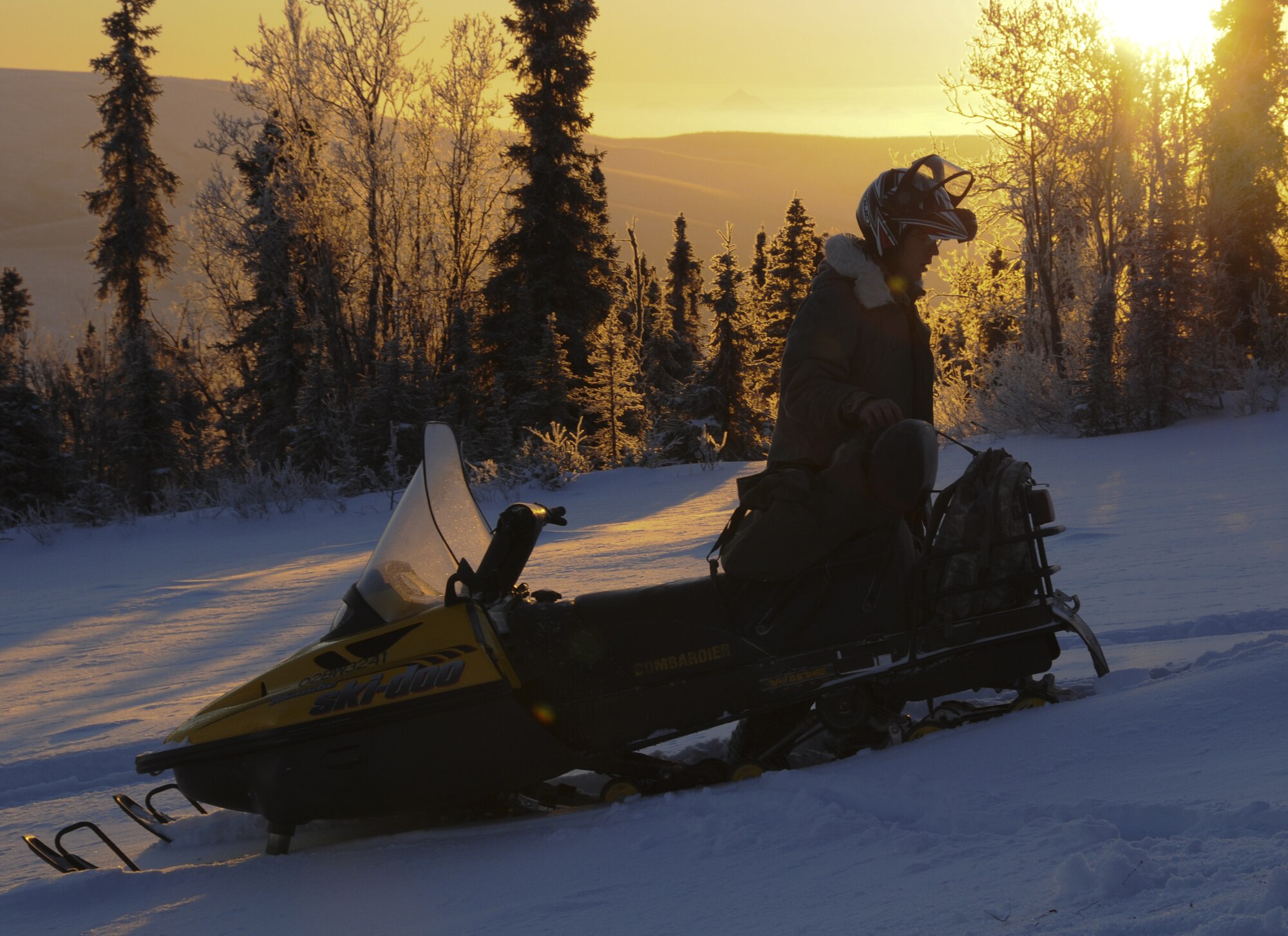 Staff Sgt. Stewart Raring removes a solar pathfinder from a snow machine on Dec. 16, 2008 at a Remote Operating Facility in the Pacific Alaska Rang Complex. The solar pathfinder will measure the intensity of sunlight for an entire year to evaluate "going green" by using solar panels to operate the facility instead of the propane that is currently being used. (U.S. Air Force photo/Airman Laura Max) 
