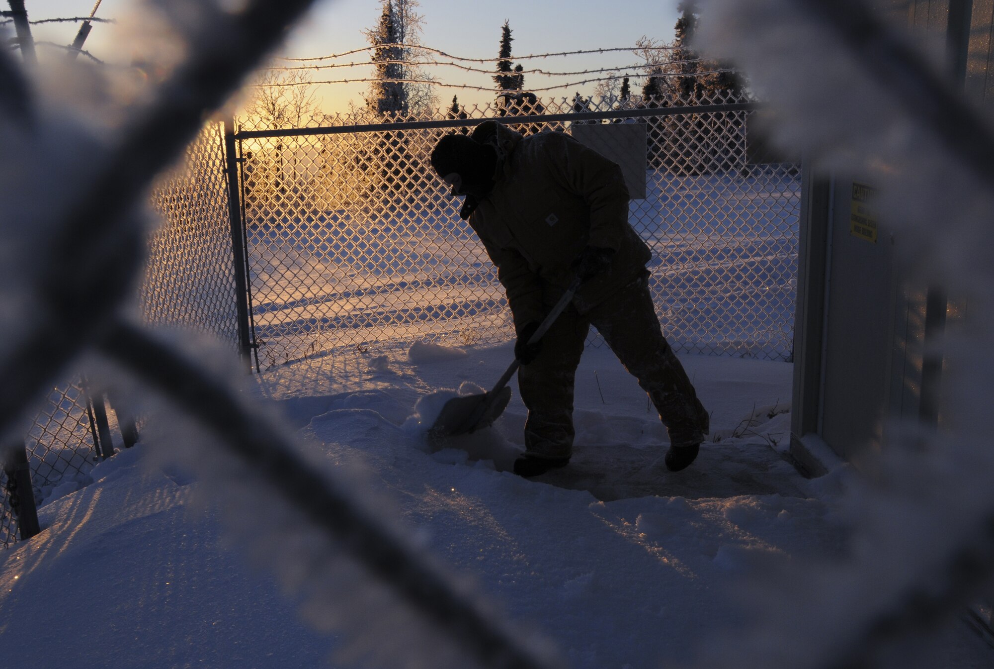 Maj. Anthony Deluca, Detachment 460 commander, clears a pathway to an  Alaska Long Period Array site Dec. 16, 2008 at a remote operating facility in the Pacific Alaska Range Complex. Det. 460 monitors for any underground nuclear seismic activity, atmospheric nuclear radiation and collects ground samples for analysis. (U.S. Air Force photo/Airman Laura Max)