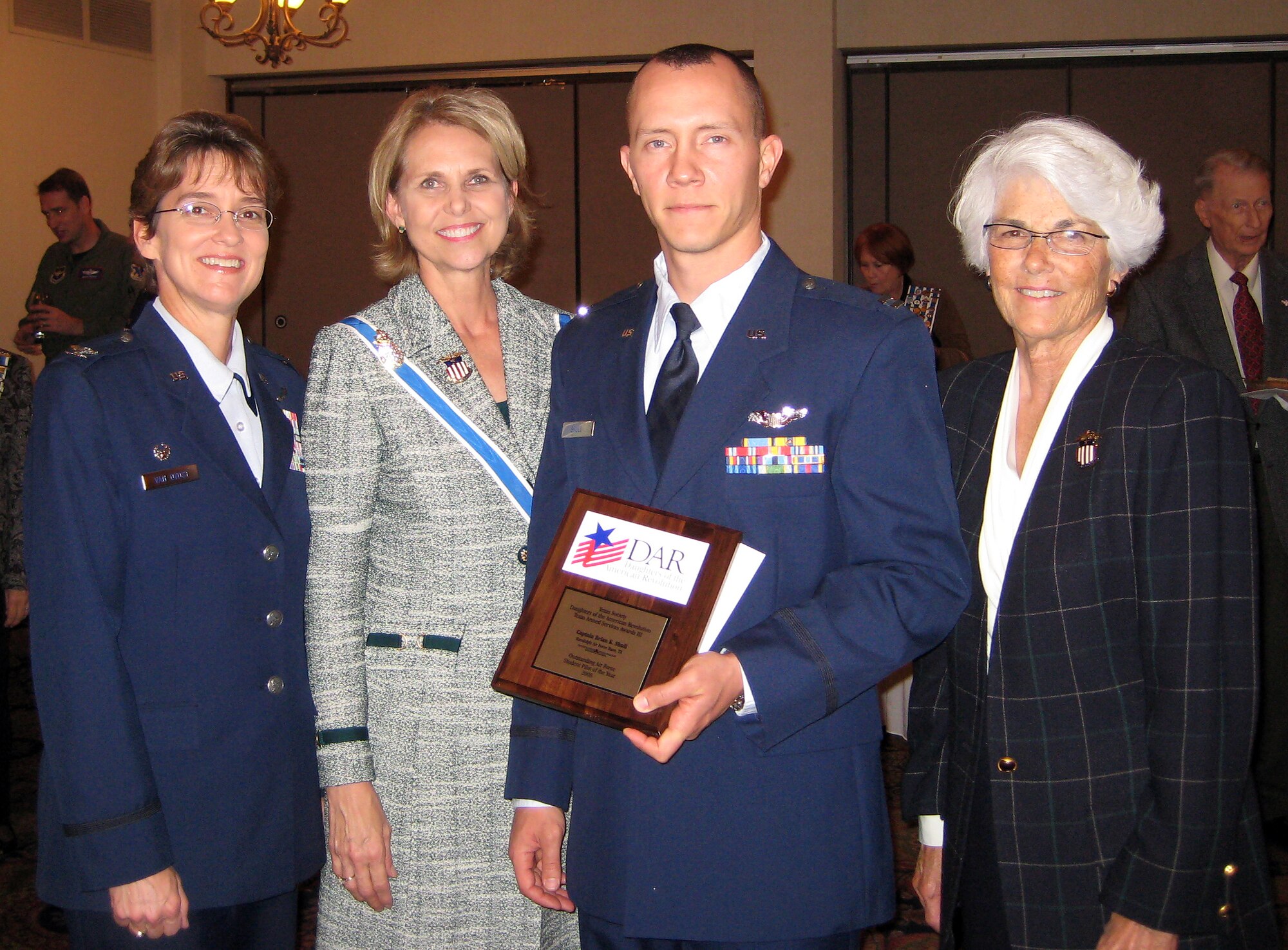 Col. Jacqueline D. Van Ovost, left, Commander of the 12th Flying Training Wing at Randolph Air Force Base, Tx., along with members of the Texas Society of the Daughters of the American Revolution, present the “2008 Outstanding Student Pilot of the Year” to Capt. Brian Shull. (U.S. Air Force photo)