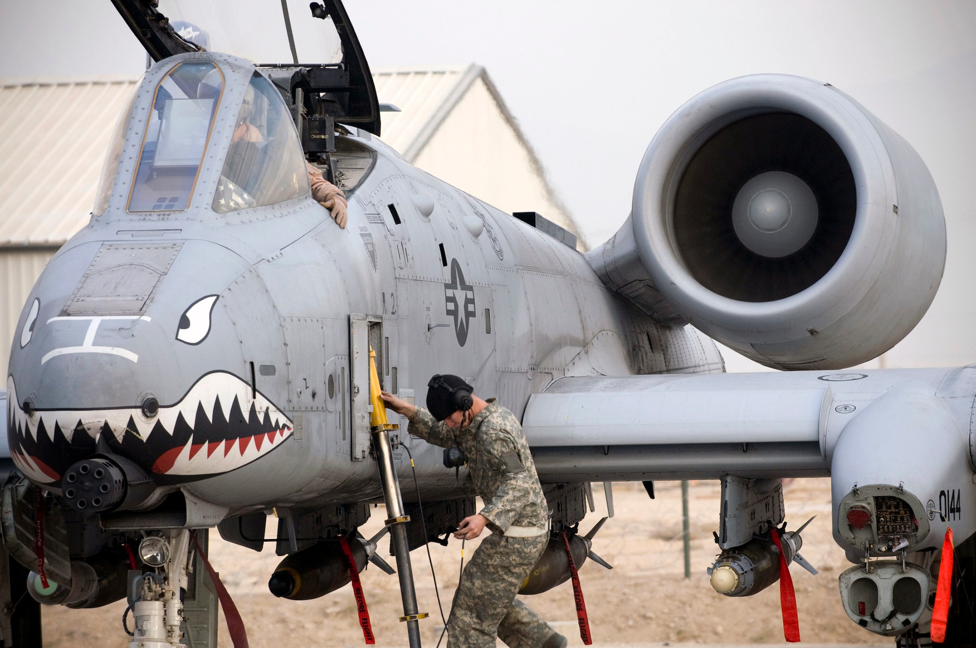 Airman 1st Class Michael Ward climbs the crew ladder to assist Capt. Eric Fleming get ready for a mission in an A-10 Thunderbolt II Dec. 2 at Bagram Airfield, Afghanistan Captain Fleming is the assistant wing weapons and tactics officer and an A-10 pilot. He is deployed from Moody Air Force Base, Ga., and hails from Philadelphia. Airman Ward is an A-10 crew chief deployed from Moody AFB, Ga. He hails from Cincinnati. (U.S. Air Force photo/Staff Sgt. Samuel Morse)