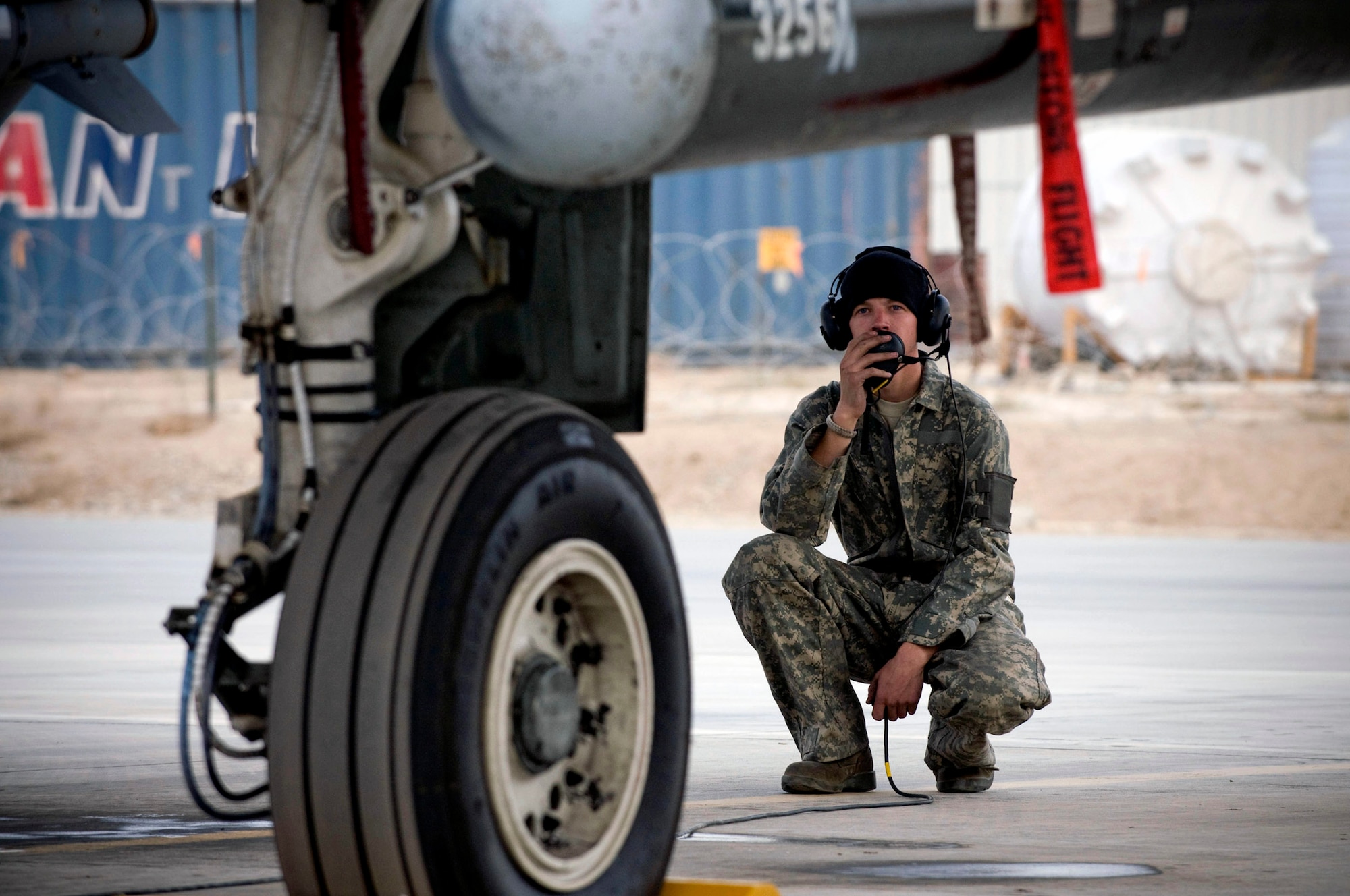 Airman 1st Class Michael Ward talks to the pilot of an A-10 Thunderbolt II during engine startup Dec. 2 at Bagram Airfield, Afghanistan. Airman Ward helps the pilot by acting as his eyes and ears outside the aircraft to make sure everything is working properly. Airman Ward is an A-10 crew chief deployed from Moody Air Force Base, Ga. He hails from Cincinnati. (U.S. Air Force photo/Staff Sgt. Samuel Morse)