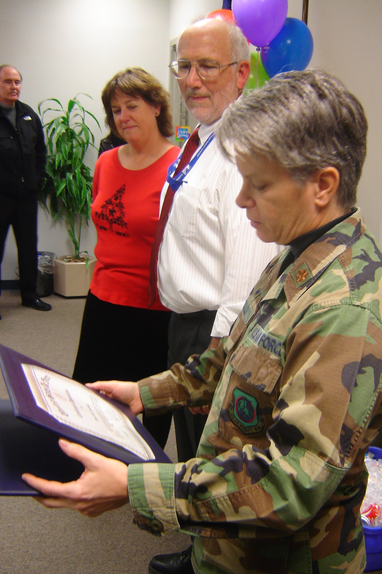 Maj. Maureen McAllen, commander, 452nd Mission Support Squadron, reads a retirement certificate during the retirement ceremony of Tom Cawthon, Chief of Civilian Personnel Flight, at the 452nd Military Personnel Flight, Dec. 16. Cawthon will retire Jan. 2 after 34 years of Air Force civil service, which includes 23 years in his current position at March Air Reserve Base, Calif.  Once he retires, Cawthon said he may do some government contract work, and he will be a volunteer soccer referee trainer with the AYSO in Redlands and throughout Southern California.  He’s been a volunteer soccer referee for 20 years. “It’s been a privilege working with so many fine professionals over the years,” he said.  “I will miss all of them, but I’m ready to move on with different things in my life.”  (U.S. Air Force photo by Will Alexander)