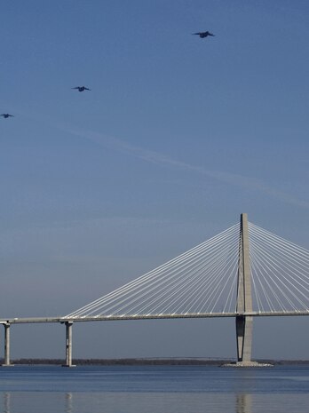 C-17s from the 437th and 315th Airlift Wings fly over the Arthur Ravenel Jr. Bridge during a training sortie involving a 13-ship formation Dec. 18. This multi-ship training demonstrates the teamwork of active-duty Airmen, Reservists and civilians to be mission-ready when the nation needs this critical capability. (U.S. Air Force photo/ Tech. Sgt. Norma Gonthier)