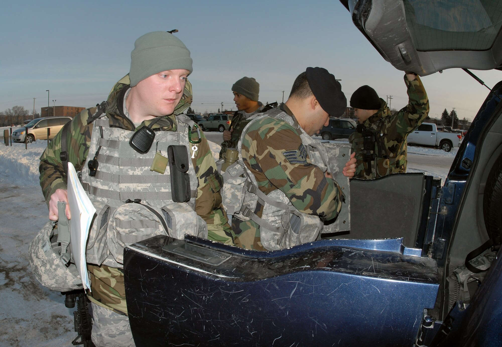 Airman 1st Class Erik Foss (left) and Staff Sgt. John Chalupa, security forces Air National Guardsmen from the North Dakota Air National Guard's 219th Security Forces Squadron in Minot, N.D., load their gear into a vehicle Dec. 18 as they prepare to dispatch into the missile fields near Minot Air Force Base.  Sergeant Chalupa and Airman Foss are the first ANG members to work the missile security mission with active-duty security forces Airmen.  (U.S. Air Force photo/Senior Master Sgt. David H. Lipp)