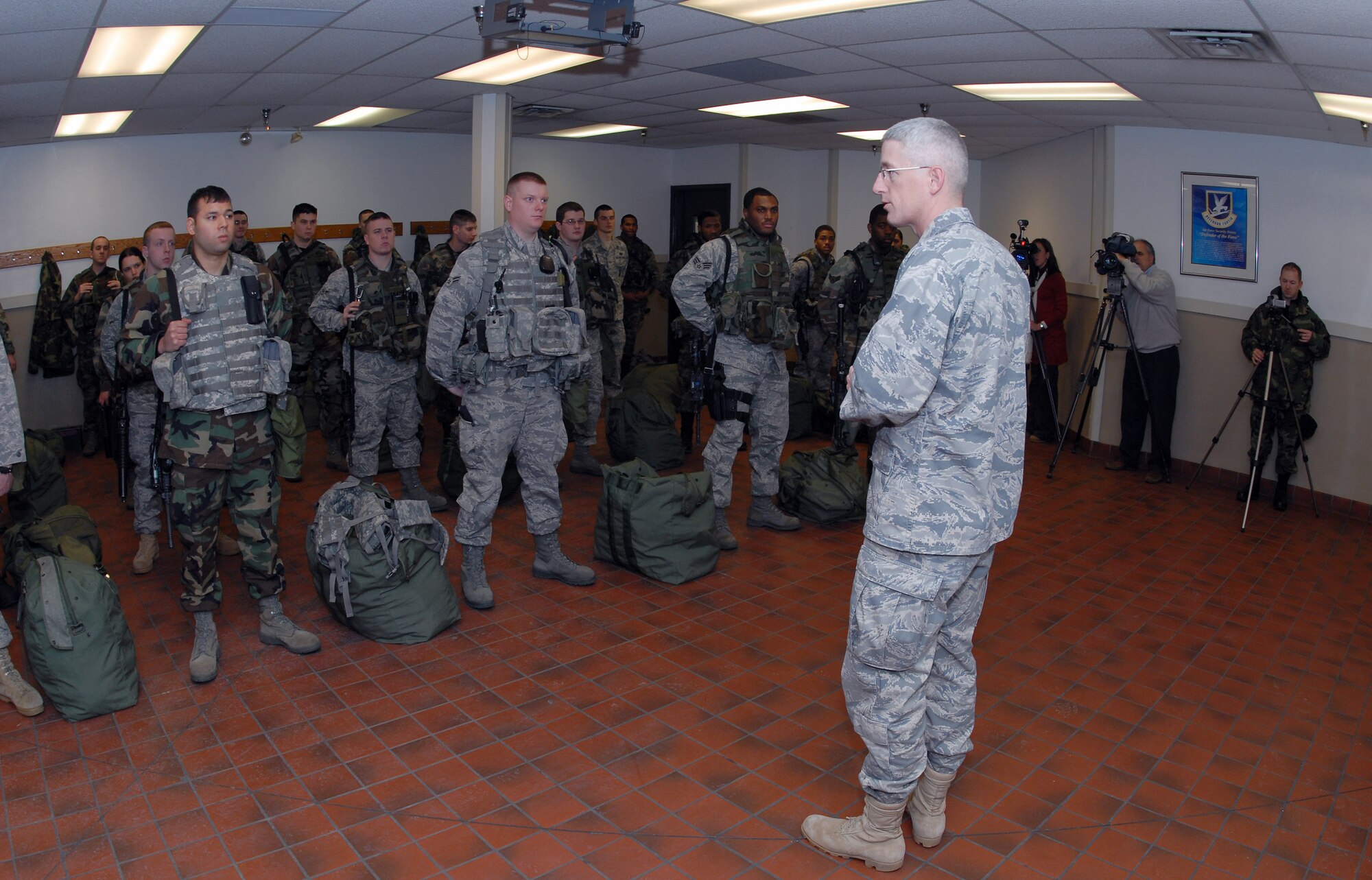 Lt. Col. Tad J. Schauer, commander of the North Dakota Air National Guard's 219th Security Forces Squadron, addresses a joint flight of active-duty Airmen from the 91st Missile Security Forces Squadron at Minot Air Force Base, N.D., and Air National Guardsmen from the 219th SFS Dec. 18 during guard mount at the base.   In the front row, Staff Sgt. John Chalupa (left) and Airman 1st Class Erik Foss (center) from the 219th SFS are the first ANG members to work the missile security mission with active-duty security forces Airmen.  (U.S. Air Force photo/Senior Master Sgt. David H. Lipp)