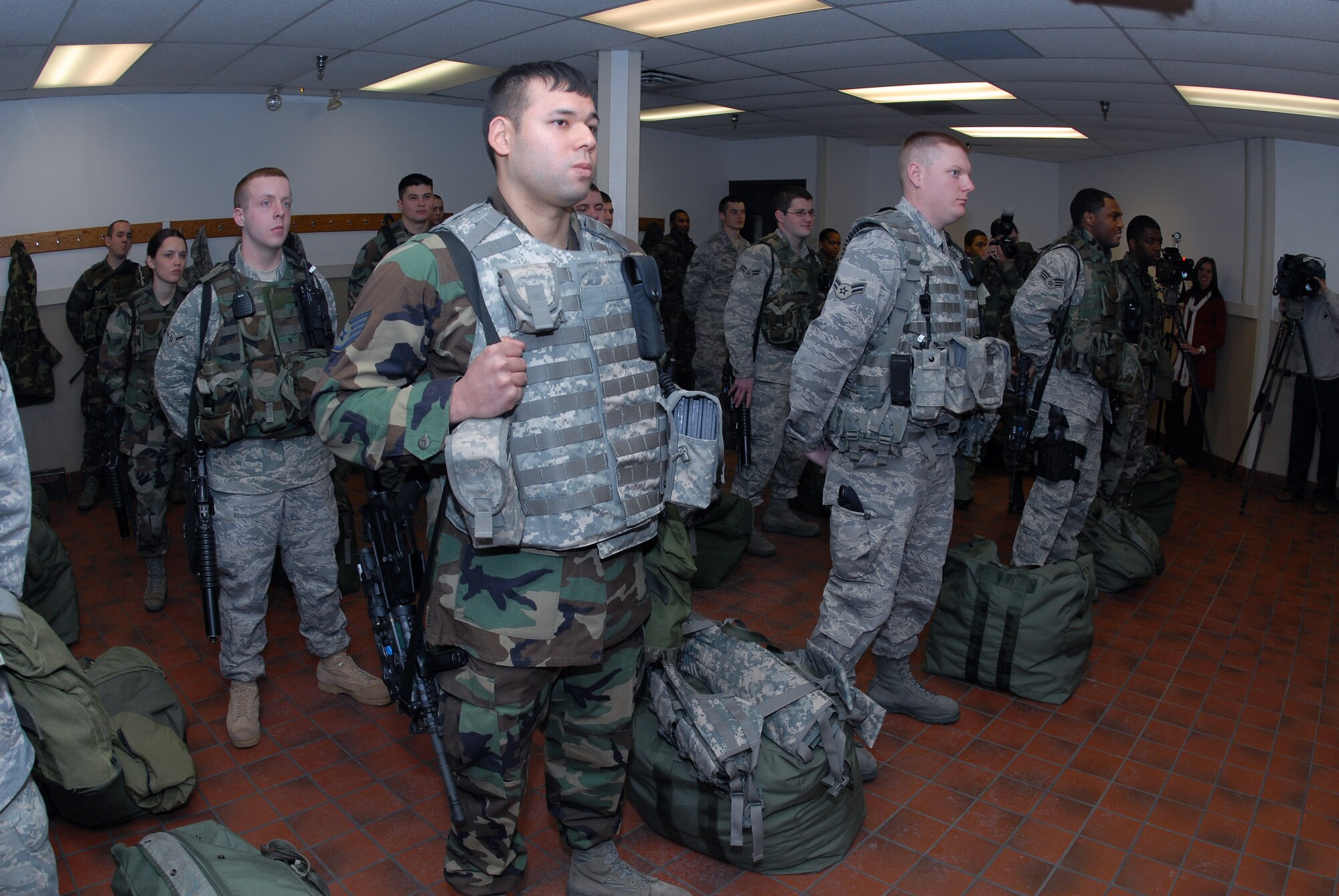 Staff Sgt. John Chalupa (left) and Airman 1st Class Erik Foss (center) from the North Dakota Air National Guard's 219th Security Forces Squadron join active-duty Airmen from the 91st Missile Security Forces Squadron at Minot Air Force Base, N.D., at guard mount Dec. 18 prior to dispatching into the Minot AFB missile fields.  Sergeant Chalupa and Airman Foss are the first ANG members to work the missile security mission with active-duty security forces Airmen.  (U.S. Air Force photo/Senior Master Sgt. David H. Lipp)