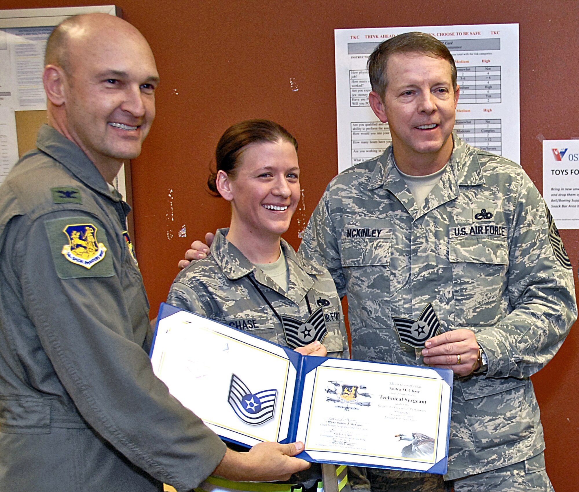 Col. Eric A. Kivi, 58th Special Operations Wing commander, left, STEP promotes Staff Sgt. Andra M. Chase to technical sergeant Dec. 10.  The colonel is assisted by Chef Master Sgt. of the Air Force Rodney J. McKinley was making a familiarization tour of New Mexico bases. The newly promoted technical sergeant is a quality assurance inspector assigned to the 58th Maintenance Group. The Stripes to Exceptional Performers means an immediate promotion to the next grade for enlisted Airmen.  U.S. Air Force Photo