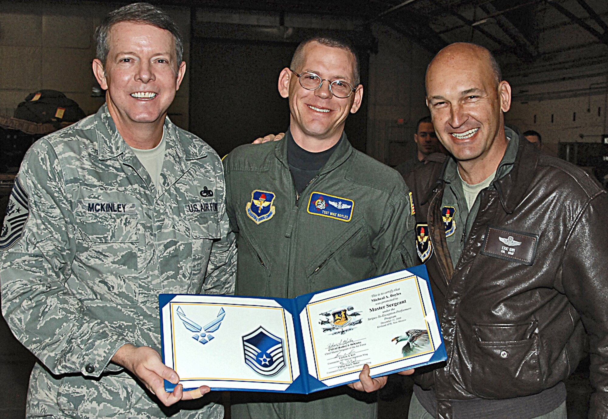 Col. Eric A. Kivi, 58th Special Operations Wing commander, left, STEP promotes Tech. Sgt. Micheal A. Boyels to master sergeant Dec. 10.  The colonel is assisted by Chef Master Sgt. of the Air Force Rodney J. McKinley was making a familiarization tour of New Mexico bases. The newly promoted master sergeant is an HC/MC-130P instructor loadmaster assigned to the 550th Special Operations Squadron. The Stripes to Exceptional Performers means an immediate promotion to the next grade for enlisted Airmen.  U.S. Air Force Photo by Todd Berenger