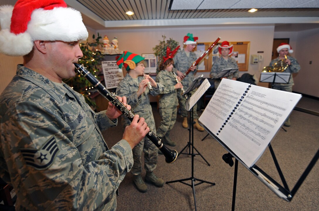 Members of The Heartland of America Band’s Winds of Freedom perform the song, “Let it snow, Let it Snow, Let it Snow”, here Dec. 17. The band caroled at various units across the base to spread holiday cheer. (U.S. Air Force photo/Airman 1st Class Joshua J. Seybert)