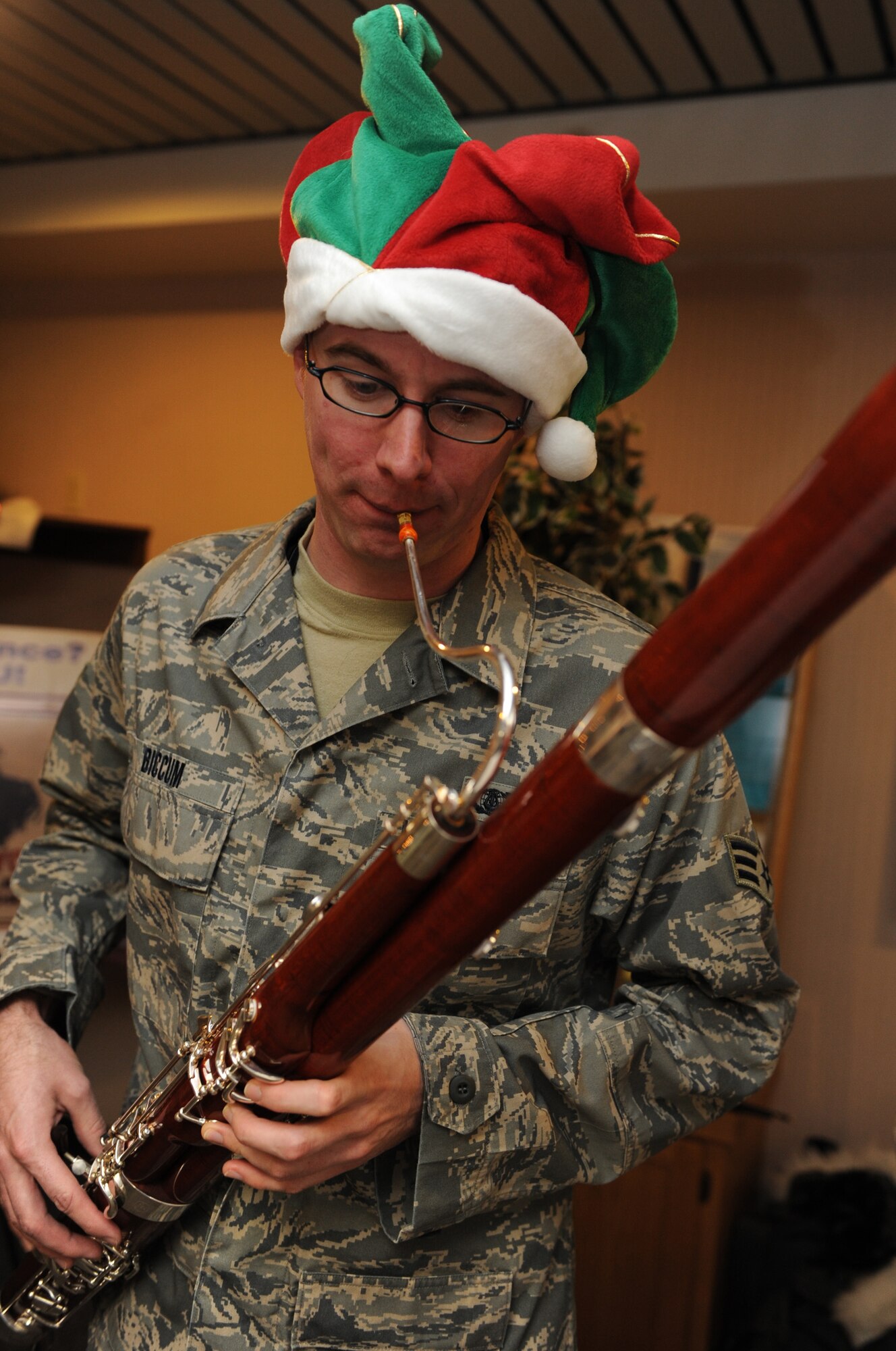 Senior Airman Jonanthan Biccum, Heartland of America Regional Band craftsman, performs holiday music with a bassoon at the 28th Medical Groupís Family Practice waiting room, here Dec. 17. The Heartland of America Band is a professional military music organization dedicated to providing local, national and global audiences with musical products, while directly impacting the overarching Air Force mission. (U.S. Air Force photo/Airman 1st Class Joshua J. Seybert)