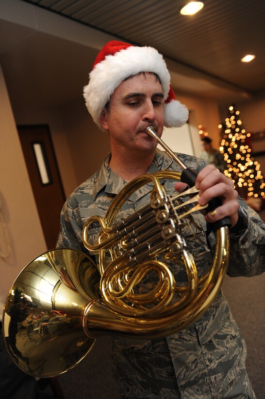 Tech. Sgt. Hughey Hancock, Heartland of America Regional Band craftsman, performs holiday music on a French horn at the 28th Medical Group’s Family Practice waiting room, here Dec. 17. The Heartland of America Band’s Winds of Freedom is a woodwind quintet composed of members of the band's larger performing ensembles. (U.S. Air Force photo/Airman 1st Class Joshua J. Seybert)