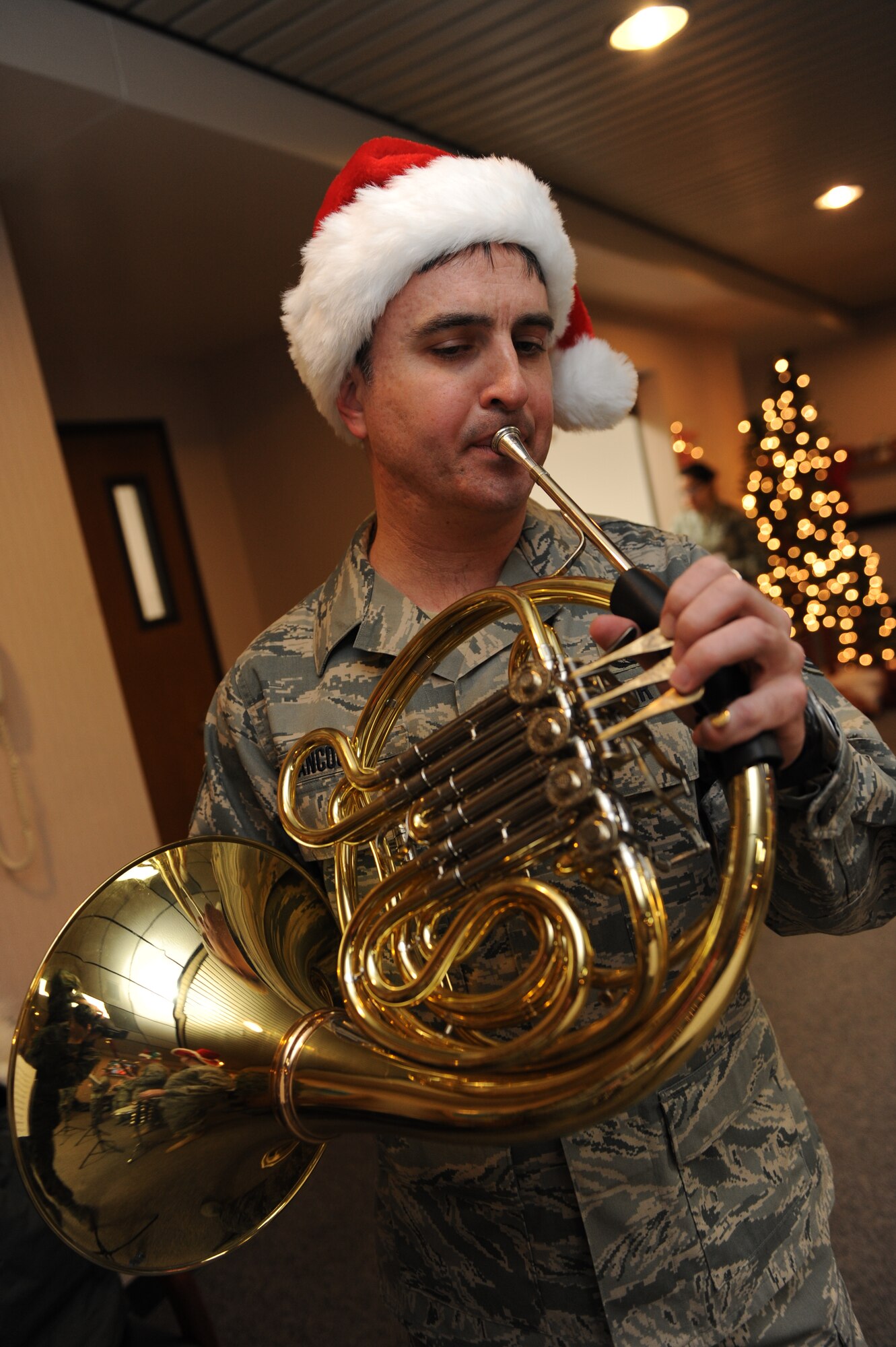 Tech. Sgt. Hughey Hancock, Heartland of America Regional Band craftsman, performs holiday music on a French horn at the 28th Medical Group’s Family Practice waiting room, here Dec. 17. The Heartland of America Band’s Winds of Freedom is a woodwind quintet composed of members of the band's larger performing ensembles. (U.S. Air Force photo/Airman 1st Class Joshua J. Seybert)