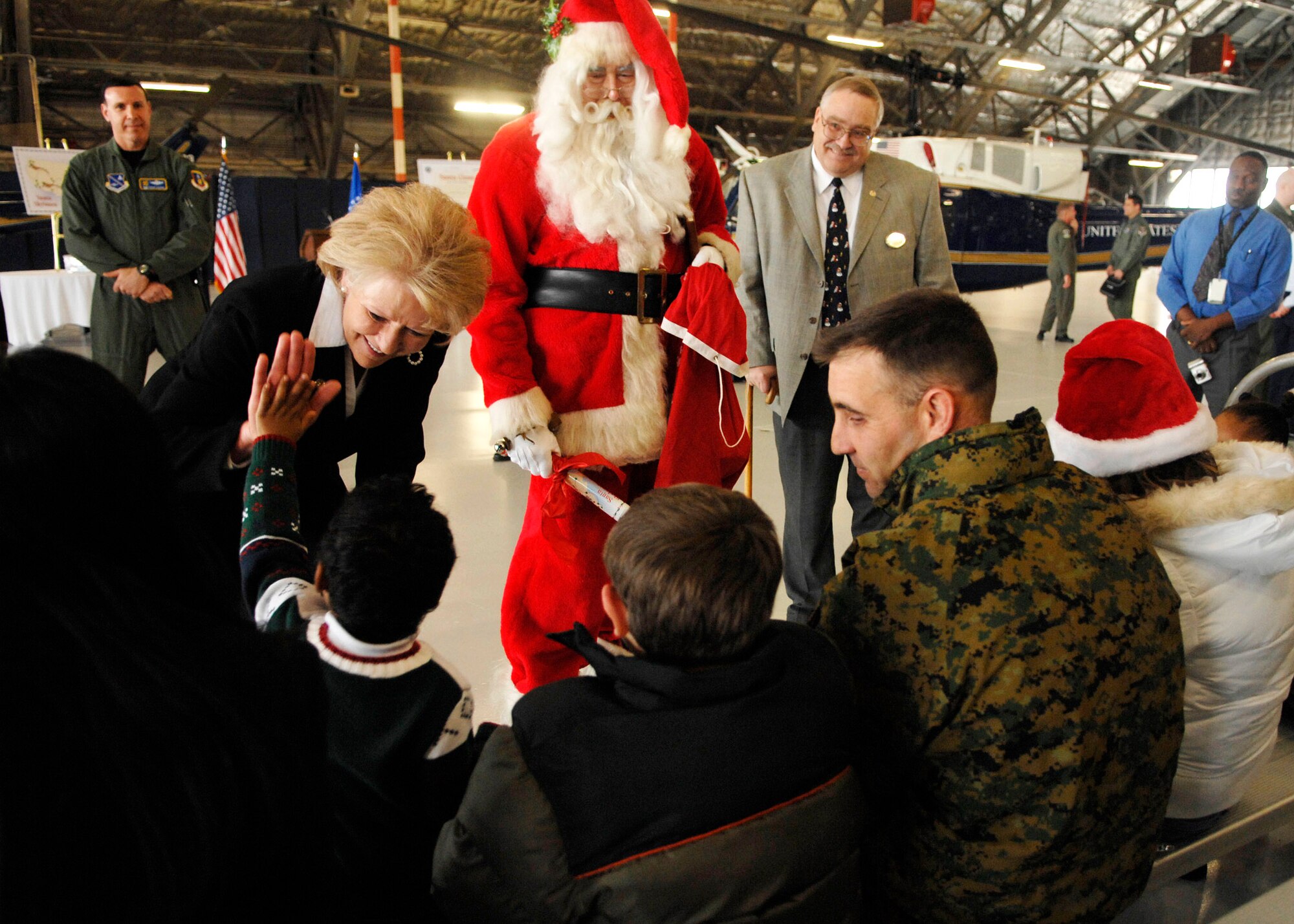 Secretary of Transportation Mary E. Peters and Santa Claus talk to military members and their children Dec. 18 at Andrews Air Force Base, Md. Secretary Peters and Santa were on base signing documents allowing Santa to fly in special military airspace called "Santa Skylanes" in order to deliver gifts to good boys and girls Christmas Eve. (U.S. Air Force photo/Senior Airman Melissa Stonecipher) 
