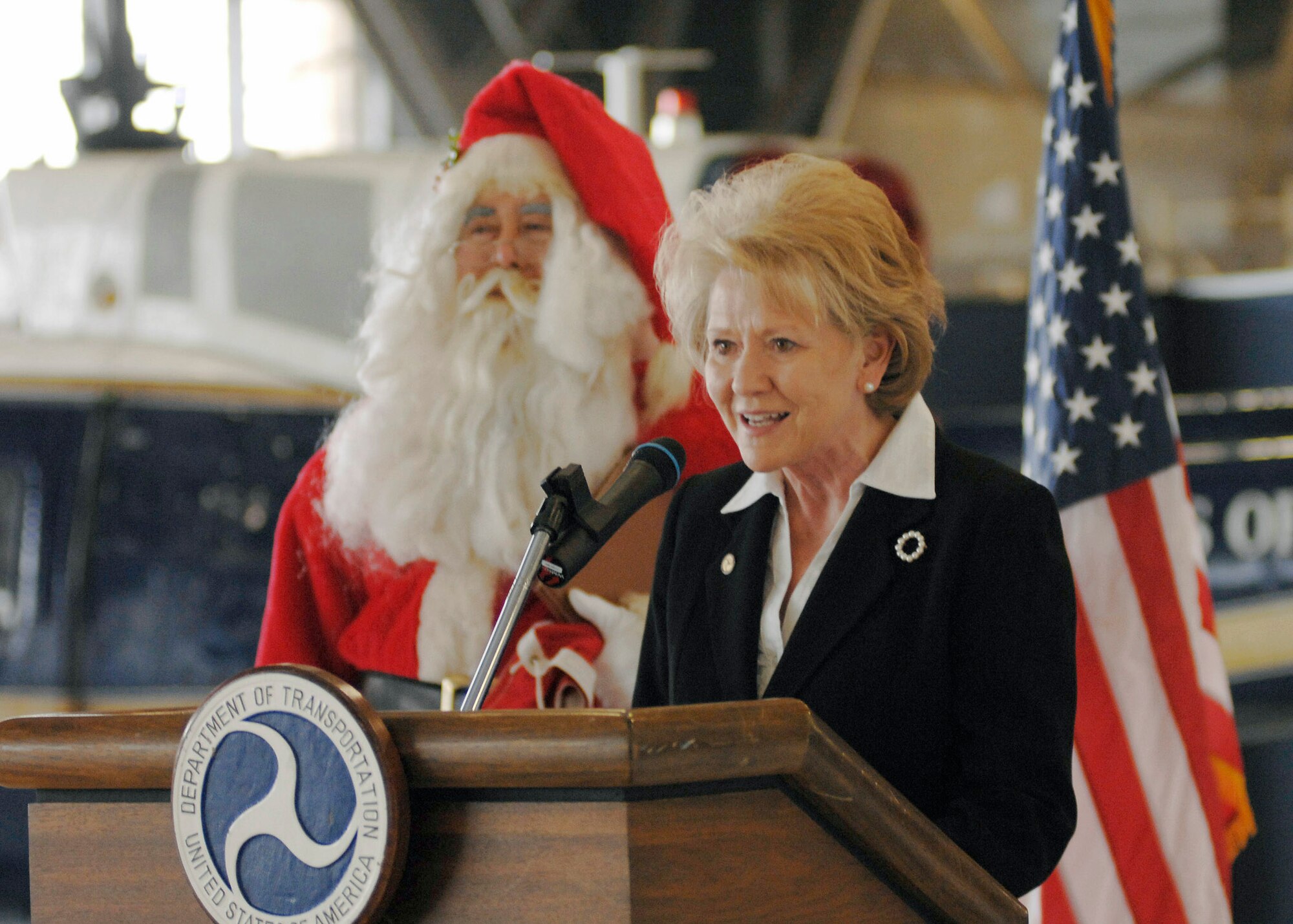 Secretary of Transportation Mary E. Peters speaks to Airmen and their families Dec. 18 at Andrews Air Force Base, Md. She spoke about Santa Claus and how the military is opening up airspace called "Santa Skylanes" so Santa can deliver gifts to good boys and girls in time for Christmas. (U.S. Air Force photo/Senior Airman Melissa Stonecipher) 
