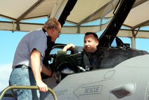 Mr. Ken Lambert, left, 482nd Fighter Wing Comptroller’s office, talks to Maj. Richard “Tricky” Wigle”, 93rd Fighter Squadron pilot, prior take-off on Dec. 19.   Mr. Lambert was invited by the 482nd Maintenance Group to participate in the “Crew Chief for a Day” program.  The program allows wing support personnel to work alongside “real” F-16 crew chiefs, familiarizing them with the rigors of aircraft maintenance and to give them a better appreciation for what happens on the flightline.  (U.S. Air Force photo/Tim Norton)