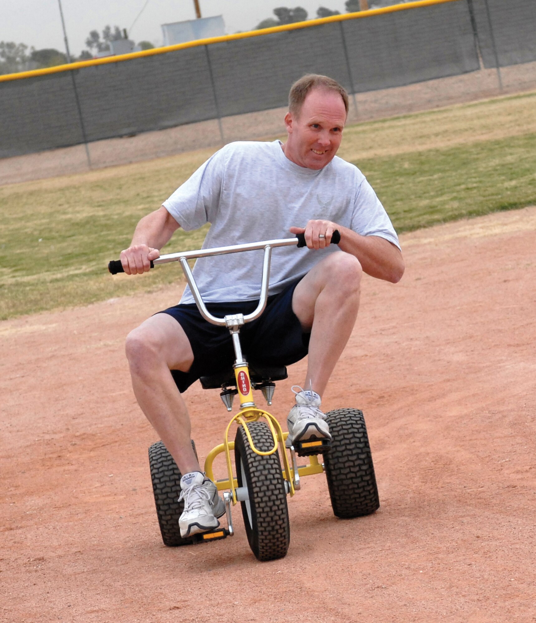 Ronald Johnson, 56th Medical Support Squadron commander, rounds third base during the tricycle race portion of the home-run derby. (U.S. Air Force photo/Deborah Silliman Wolfe)