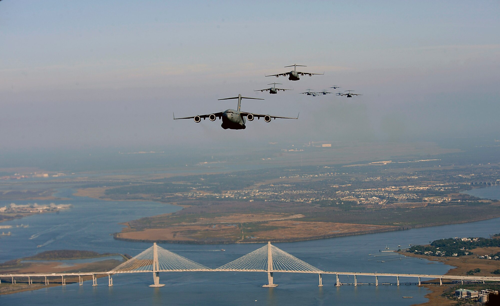 C-17 Globemaster IIIs from the 437th and 315th airlift wings fly in formation Dec. 18 over Charleston, S.C. The C-17s participated in a strategic brigade airdrop exercise involving a 13-ship formation to meet the Army's goal of airdropping a brigade's worth of troops and equipment (about 3,250 Soldiers and 3,450 tons of equipment). The C-17s are from Charleston Air Force Base, S.C. (U.S. Air Force photo/Tech. Sgt. Jeremy Lock)