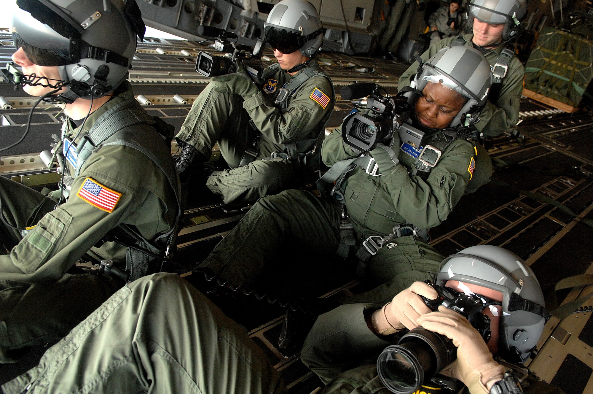 Airmen from the 1st Combat Camera Squadron photograph C-17 Globemaster IIIs from the 437th and 315th airlift wings flying in formation during a strategic brigade airdrop exercise involving a 13-ship formation Dec. 18 from Charleston Air Force Base, S.C. C-17s must be able to meet the Army's goal of airdropping a brigade's worth of troops and equipment (about 3,250 Soldiers and 3,450 tons of equipment). The Airmen of the 1st CCS are assigned to Charleston AFB. (U.S. Air Force photo/Tech. Sgt. Jeremy Lock) 