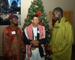 Master Sgt. Bertin Mbaidoloum, Chad, Maj. Yaha Alyusrei, Yemen, and First Lt. Ibra Diakhate, Senegal, discuss holiday traditions during the Defense Language Institute English Language Center holiday social Dec. 13 at Lackland Air Force Base, Texas. The DLIELC provides English language training to international military students while giving them opportunities to see and experience American culture. (USAF photo by Alan Boedeker)    