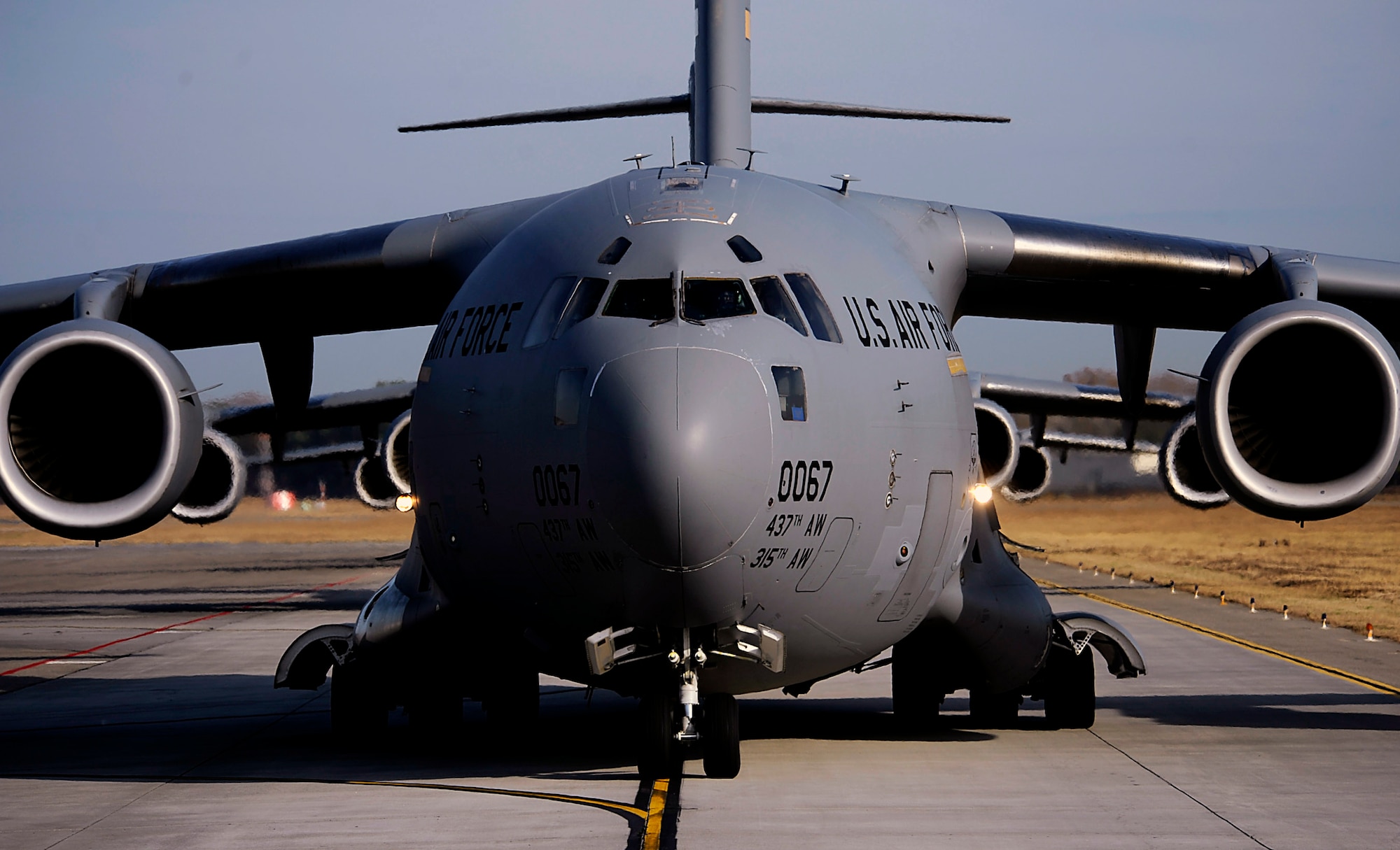 C-17 Globemaster IIIs from the 437th and 315th airlift wings prepare for takeoff during a strategic brigade airdrop exercise involving a 13-ship formation Dec. 18 from Charleston Air Force Base, S.C. C-17 Globemaster III transporters must be able to meet the Army's goal of airdropping a brigade's worth of troops and equipment (about 3,250 Soldiers and 3,450 tons of equipment). Charleston AFB aircraft currently account for half of the Air Force strategic brigade airdrop requirement. (U.S. Air Force photo/Tech. Sgt. Jeremy Lock) 