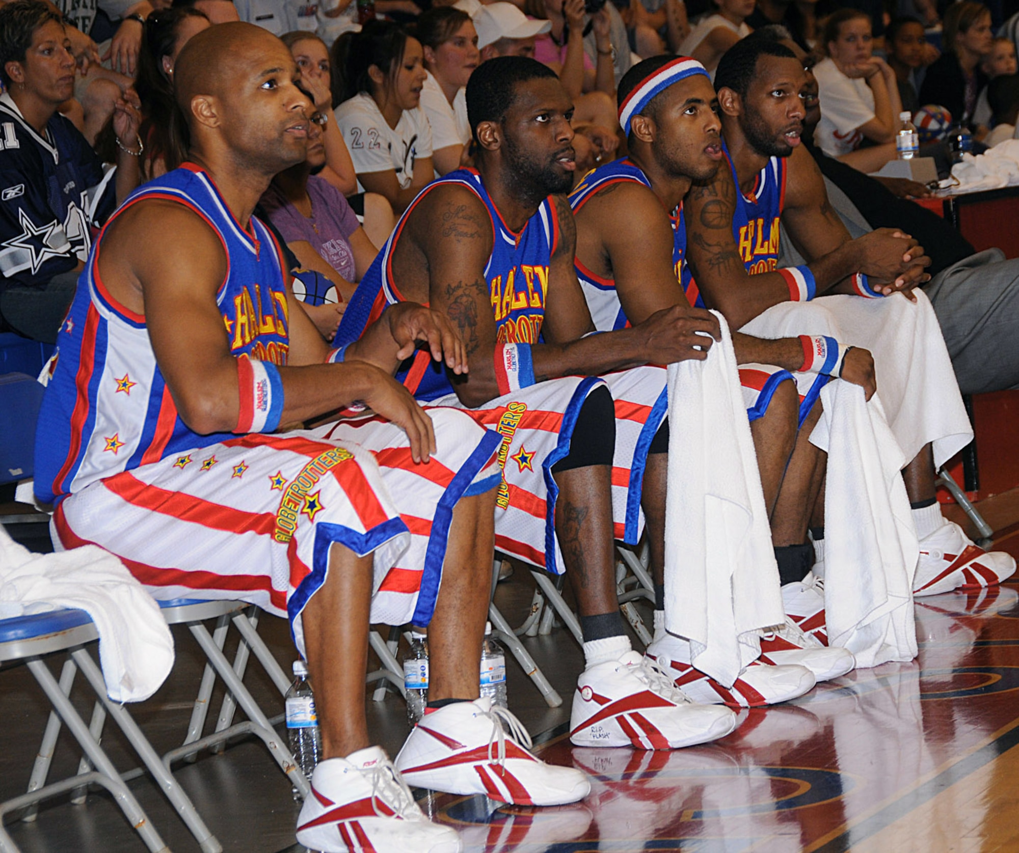 Harlem Globetrotters look on as their teammates battle the Washington Generals Dec. 15 at Andersen Air Force Base, Guam. The Globetrotters have been undefeated for 83 years. (U.S. Air Force photo/Staff Sgt. Jamie Lessard) 
