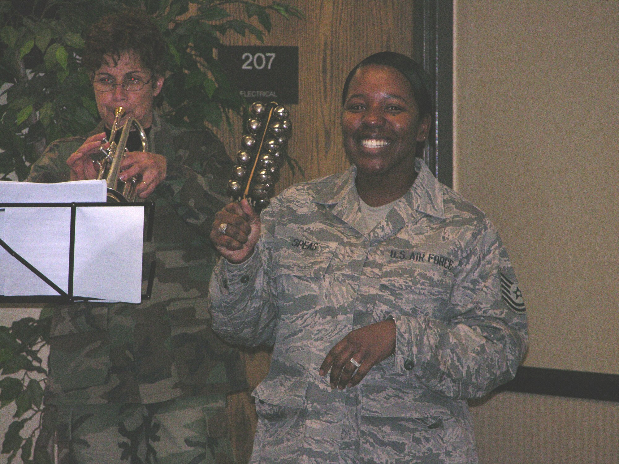 SEYMOUR JOHNSON AIR FORCE BASE, N.C. -- Tech. Sgt. Diane Speas (right) makes some joyful holiday noise alongside the members of the Heritage of America Band out of Langley Air Force Base. Recently five members of the band toured Seymour Johnson spreading holiday cheer through their music, conducting 10-minute concerts in various squadrons and offices. Sgt. Speas is a Reservist with the 916th Mission Support Group.