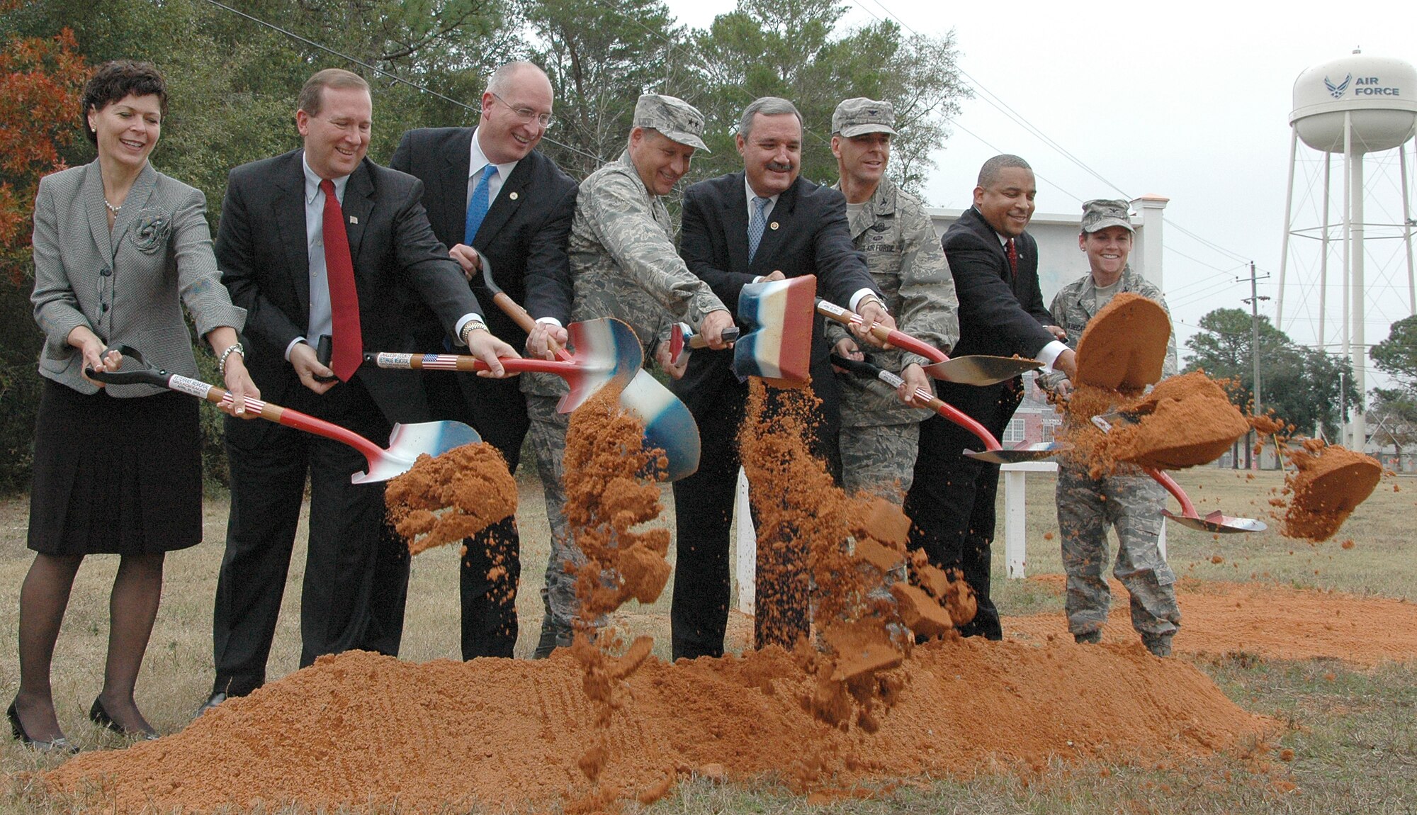 EGLIN AIR FORCE BASE, Fla. -- (Left to right) Trecia Chedister, Emerald Coast Fisher House founding member; Tom Rice, Emerald Coast Fisher House board member; David Coker. President of the Fisher House Foundation; Maj. Gen. David Eidsaune, Air Armament Center commander and the Air Force Program Executive Officer for Weapons; Congressman Jeff Miller; Col. Bruce McClintock, 96th Air Base Wing commander; Robin Baily, 96th Air Base Wing Director of Staff; and Col. Tama Van Decar, 96th Medical Group commander; shoveled the first bit of earth during the groundbreaking of the Emerald Coast Fisher House. There are currently 40 Fisher Houses worldwide. Fisher Houses provide a home-away-from-home for the families of servicemembers while loved ones are receiving medical treatment at military and Veteran Affairs facilities. (U.S. Air Force photo/Staff Sgt. Stacia Zachary)