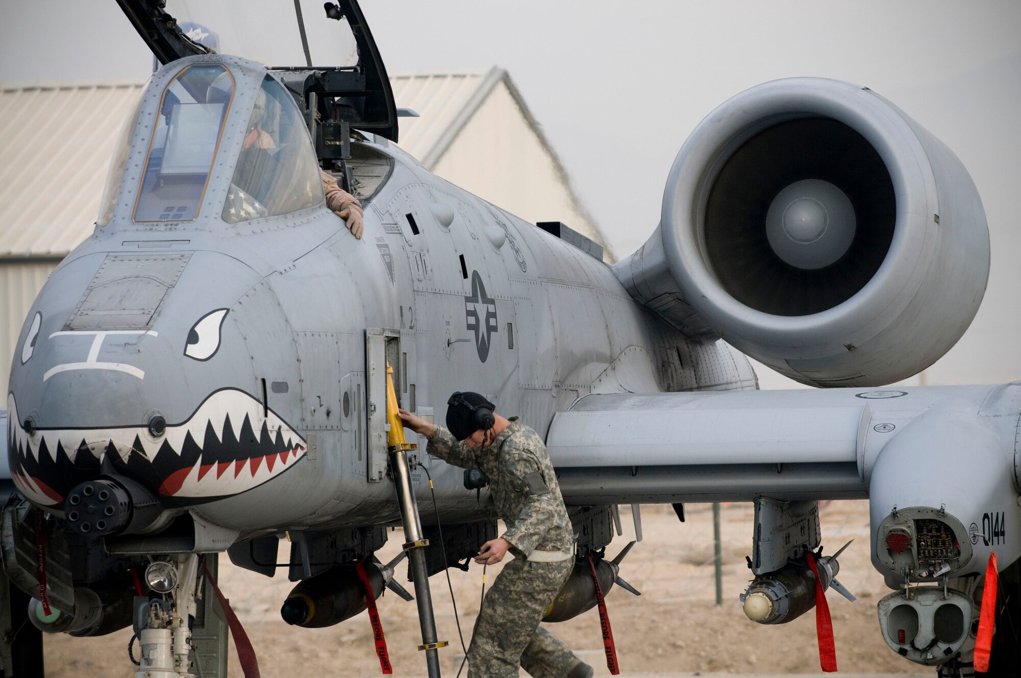 A-10 Thunderbolt II crewchief Airman 1st Class Michael Ward climbs the crew ladder to assist pilot Capt. Eric Fleming at Bagram Air Field, Afghanistan, Dec. 2. The pilots, crewchiefs and aircraft all deployed from the same unit at Moody Air Force Base, Ga., so that they would be able to assume duties and missions right from their first day at Bagram Air Field. Captain Fleming is from Philadelphia, Pa., and Airman Ward is from Cincinnati, Ohio. (U.S. Air Force photo by Staff Sgt. Samuel Morse)(Released)