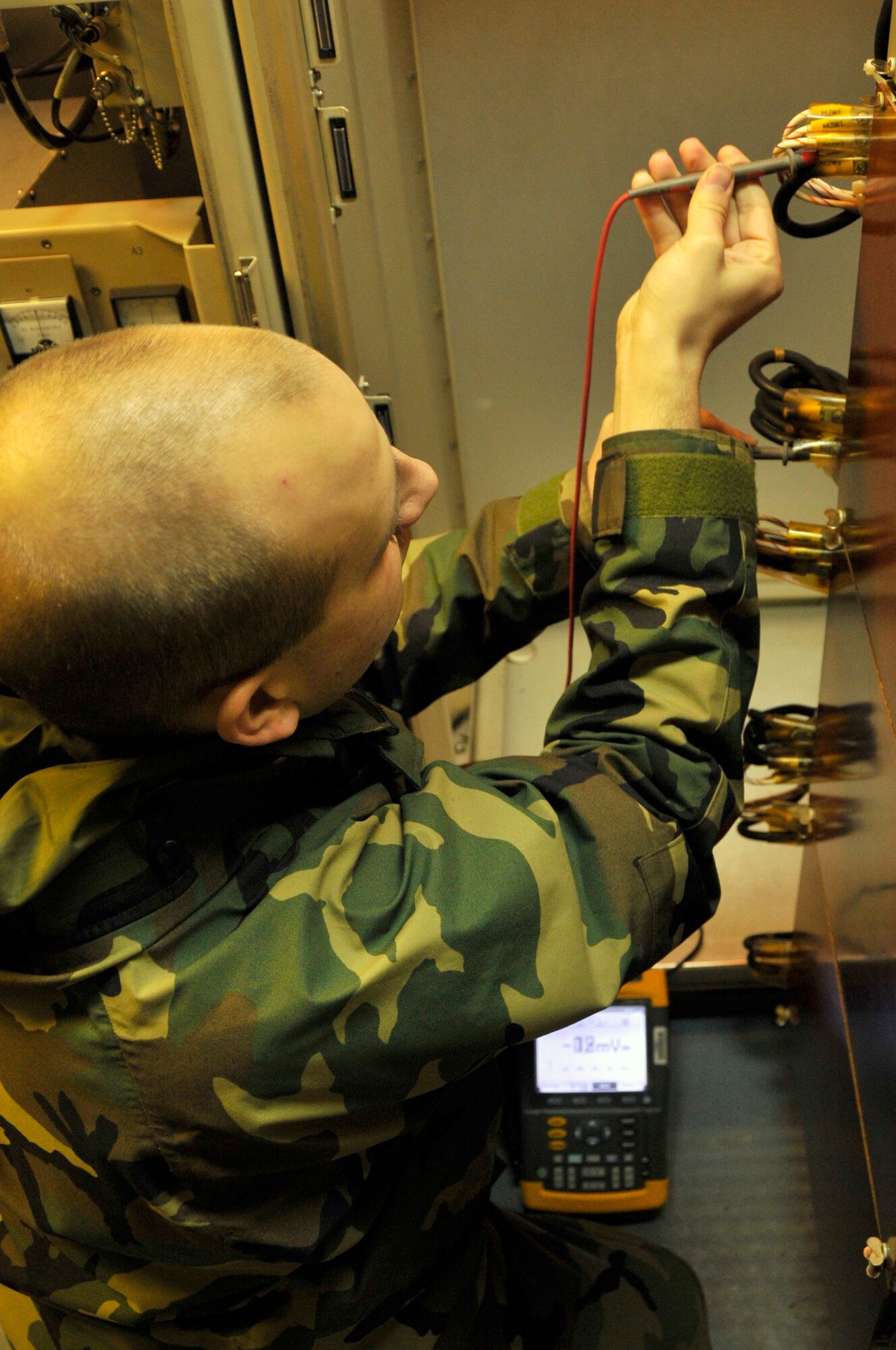 Staff Sgt. James Hammond, 48th Communications Squadron NCOIC of ground radar systems, performs a inspection of voltage levels on the airport surveillance radar's processor rack, back plane Dec. 9 at RAF Lakenheath, England. Ground radar systems craftsman inspect and repair the radar early morning every day before being turned over to radar approach control for that days flying operations.(U.S. Air Force photo by Airman 1st Class Perry Aston)