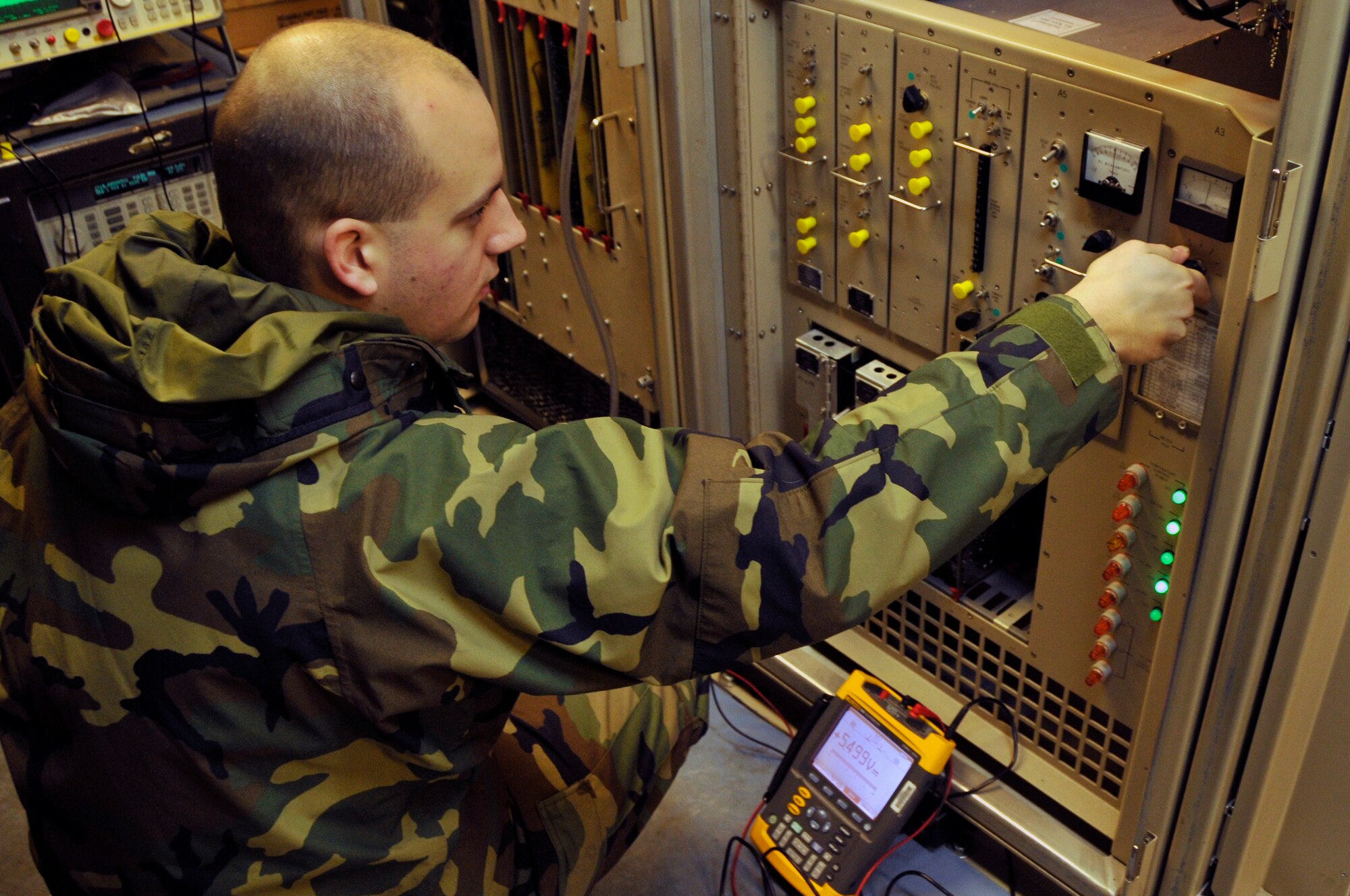 Staff Sgt. James Hammond, 48th Communications Squadron NCO in-charge of ground radar systems, performs an inspection of voltage levels on the airport surveillance radar's processor rack, back plane Dec. 9 at RAF Lakenheath, England. Ground radar systems craftsman inspect and repair the radar early morning every day before being turned over to radar approach control for that days flying operations.(U.S. Air Force photo by Airman 1st Class Perry Aston)