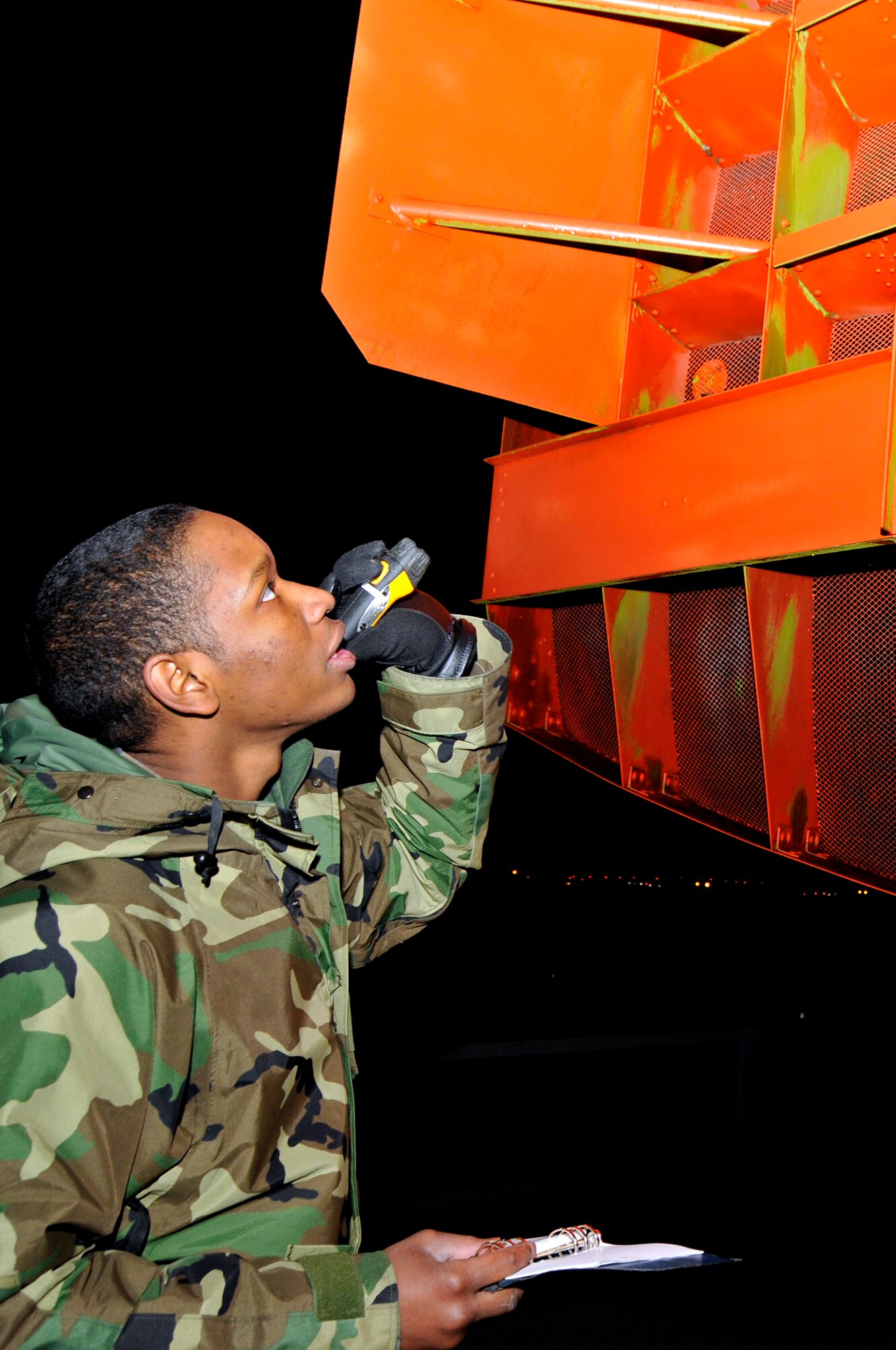 Airman 1st Class Lawrence Stafford, 48th Communications Squadron ground radar systems apprentice, inspects the airport surveillance radar antenna for damage Dec. 9 at RAF Lakenheath, England. Weekly inspections on the airport surveillance radar antenna must be performed to ensure proper operation. (U.S. Air Force photo by Airman 1st Class Perry Aston)