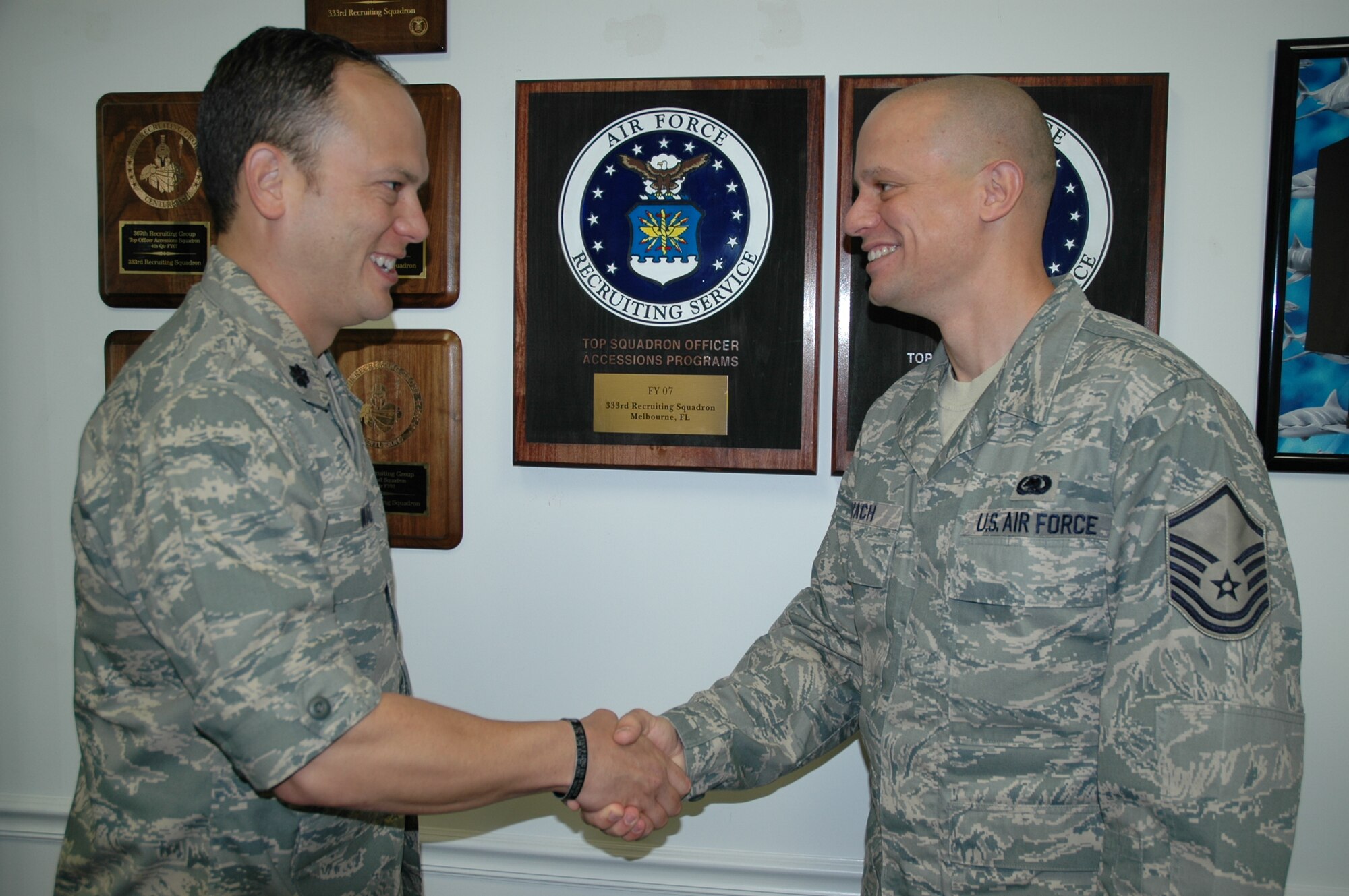 Master Sgt. Micheal Kovach (right) is congratulated by 333rd Recruiting Squadron Commander Lt. Col. Jeffrey Waters on being named one of the Air Force’s top recruiters for 2008. The other winner from the 333rd RCS, Staff Sgt. Alpha Tyler, was recently reassigned to Arizona. (U.S. Air Force photo by Airman 1st Class David Dobrydney)