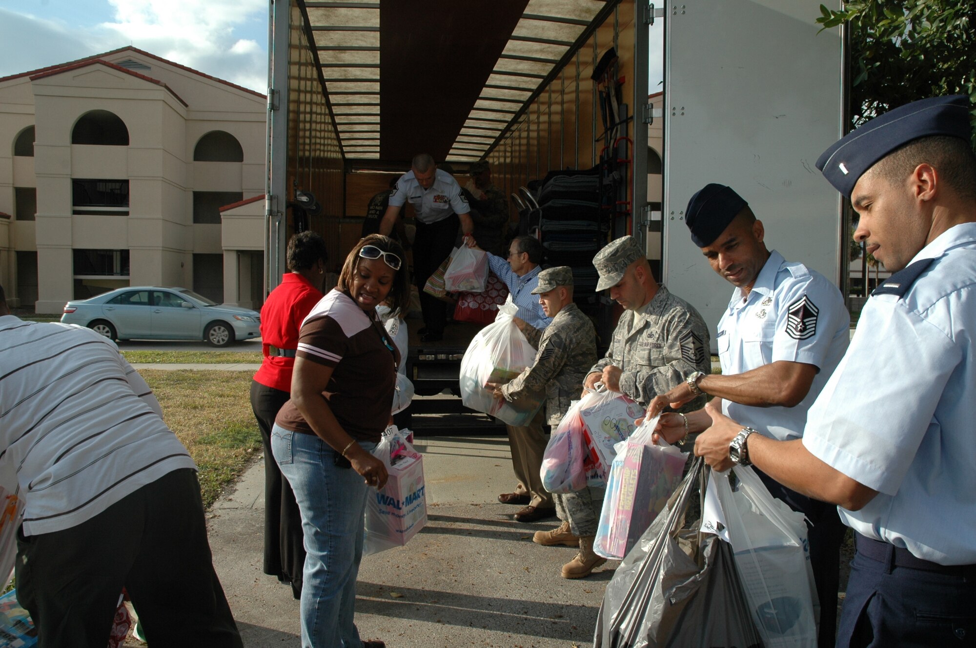 Members of the 45th Space Wing help members from the Center for Brevard County fill up a truckload of toys Dec. 8 at the Professional Development Center. The toys will go to 158 local foster children. “In these tough economic times, it warms my heart to know the men and women of Patrick Air Force Base and Cape Canaveral Air Force Station came through to support our Brevard County foster children,” said Senior Master Sgt. Jeffrey Lizak, first sergeant for the 45th Launch and Operations Groups. (U.S. photo by Mike Francisco)