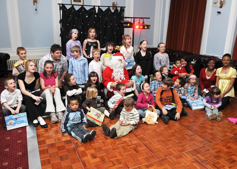 Family members, along with Santa Claus shout out “Merry Christmas” at the conclusion of the deployed spouse’s luncheon Dec. 7, 2008, at RAF Marham, England. The luncheon was put together for families of deployed servicemembers serving in the United States and the Royal air forces, the opportunity to meet other families with loved ones deployed during the holidays. Santa made a special appearance and handed out gifts to all children in attendance. (U.S. Air Force photo by Staff Sgt. Jerry Fleshman)