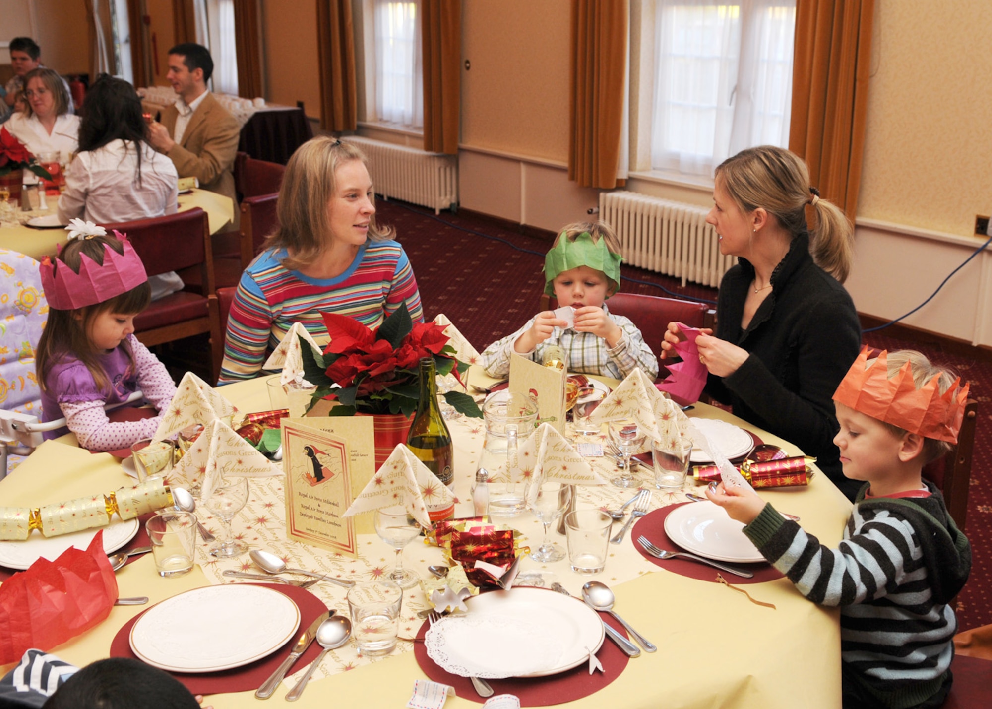 Mandi Clouse and daughter Makayla, age 2 (left) from RAF Mildenhall, engage in conversation with Clare Smith and her sons William, 4, (middle) and James, 3, (right) from RAF Marham, during the deployed spouses luncheon Dec. 7, 2008, at RAF Marham, England. The luncheon was put together for families of deployed servicemembers serving in the United States and the Royal air forces, the opportunity to meet other families while loved ones are deployed during the holidays. (U.S. Air Force photo by Staff Sgt. Jerry Fleshman)
