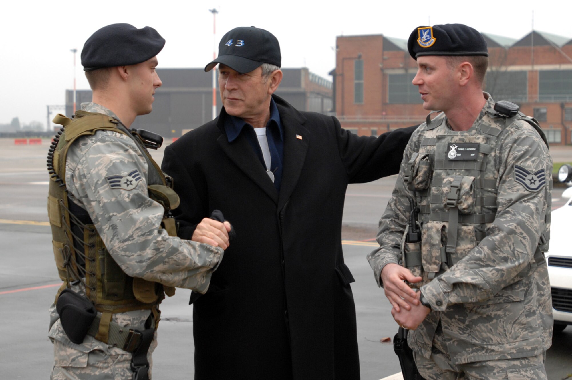 President George W. Bush shakes hands with Senior Airmen Keith Garrie, left, and Staff Sgt. Thomas Kazmierski, both 100th Security Forces Airmen, during a brief visit here Dec. 15, 2008. (U.S. Air Force photo by Senior Airman Teresa Hawkins)