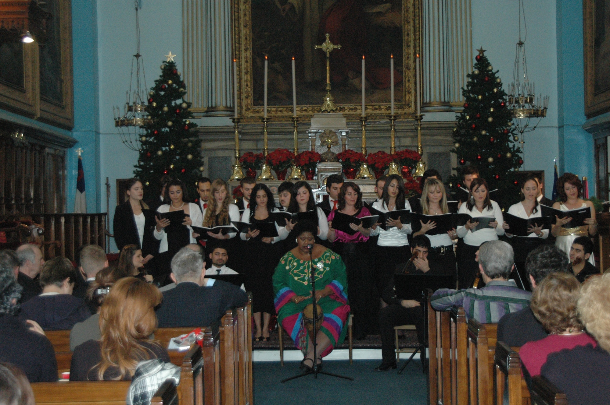 Dokuz Eylül University State Conservatory faculty and students, led by prof. Jeanette Thompson,sing “Kumbaya,” an African folk song,  during the Christmas Concert and Tree Lighting Ceremony held at the at the Izmir Chapel Dec. 5.  (U.S. Air Force photo by Tanju Varlikli)
