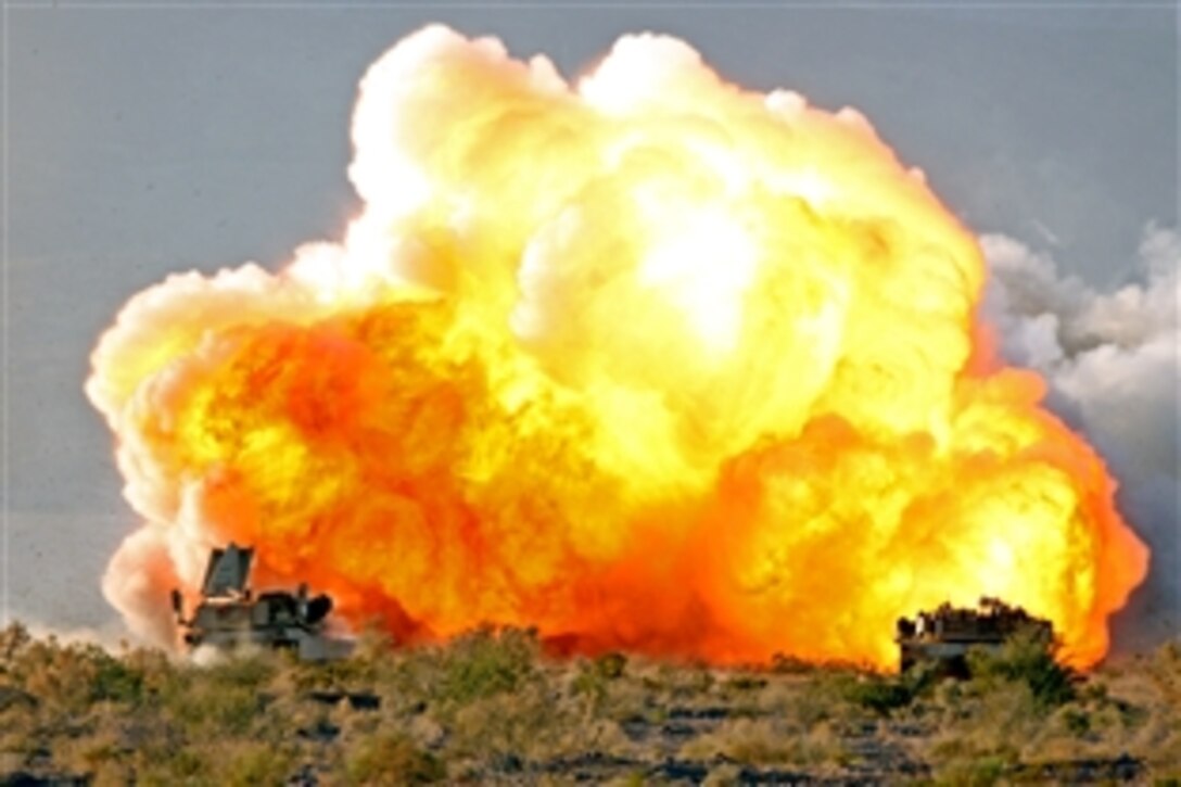 A mine-clearing line charge explodes as U.S. Marines aboard M1A1 Abrams tanks prepare to assault through their objective during a combined arms exercise on Twentynine Palms, Calif., Dec. 11, 2008.