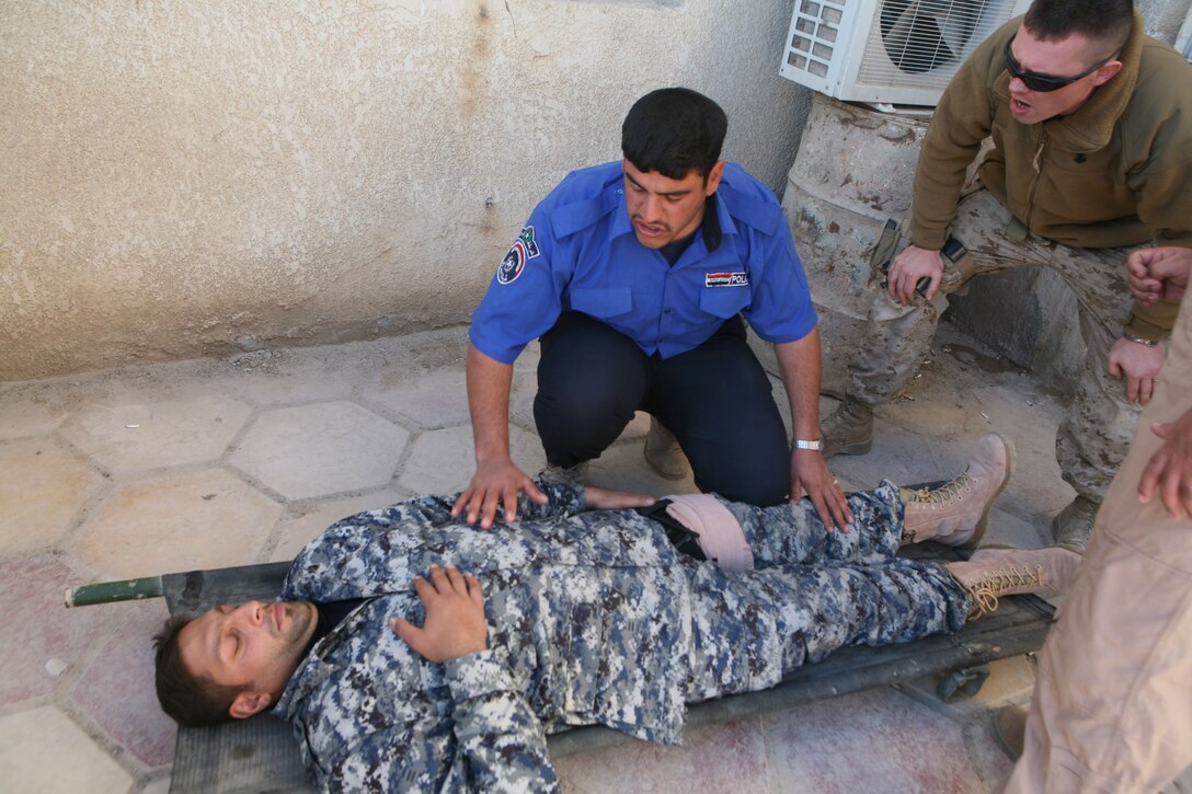 Iraqi Police from several precincts in Fallujah, Iraq, take part in medical training at the Joint Command Center in Fallujah, Dec. 19. Navy Corpsmen with Headquarter Company, 1st Battalion, 4th Marine Regiment, Regimental Combat Team 1, taught a four-day Combat Life Saver course to the policemen.
