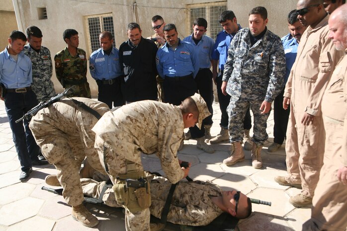 Iraqi Police from several precincts in Fallujah, Iraq, take part in medical training at the Joint Command Center in Fallujah, Dec. 19. Navy Corpsmen with Headquarter Company, 1st Battalion, 4th Marine Regiment, Regimental Combat Team 1, taught a four-day Combat Life Saver course to the policemen.