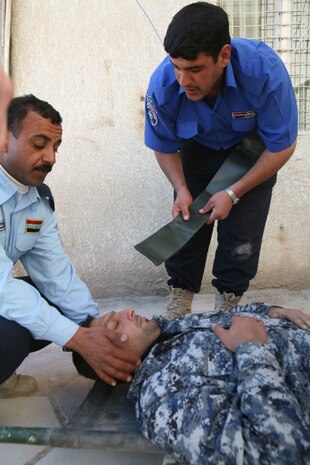 Iraqi Police from several precincts in Fallujah, Iraq, take part in medical training at the Joint Command Center in Fallujah, Dec. 19. Navy Corpsmen with Headquarter Company, 1st Battalion, 4th Marine Regiment, Regimental Combat Team 1, taught a four-day Combat Life Saver course to the policemen.