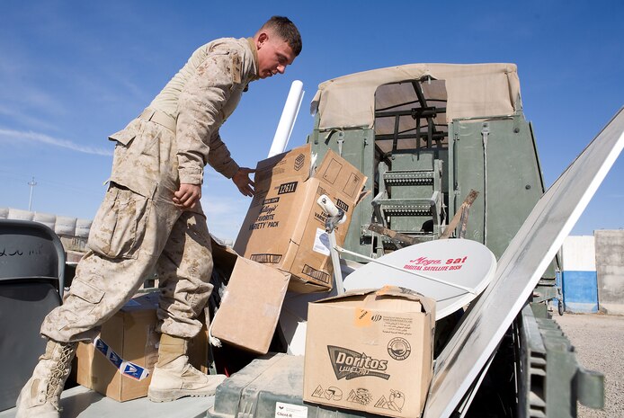 A MARINE with Company C, Task Force 1st Battalion, 3rd Marine Regiment, Regimental Combat Team 1, finishes loading equipment from Karmah Iraqi Police Station, December 19. Marines have been stationed at the police station since the beginning of the deployment, supporting Iraqi police and helping the progress operationaly. As the Iraqi Police mature in proficiency, Marines no longer need to be there and have left throughout the month of December. (Official U.S. Marine Corps Photo / Released)