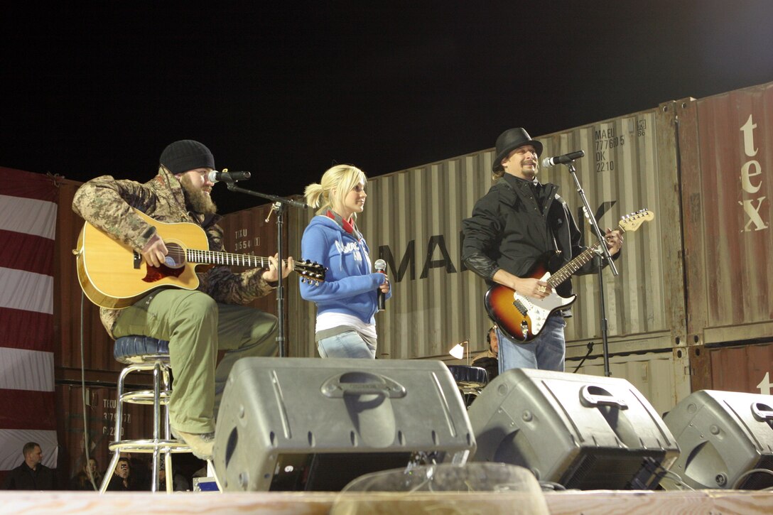 Musicians Zac Brown, Kellie Pickler and Kid Rock perform a song for service members aboard Al Asad Air Base, Iraq, Dec. 19.  The musicians joined comedians Lewis Black, Kathleen Madigan, John Bowman and Tichina Arnold as part of a USO tour to entertain service members deployed overseas during the holidays.  Marines and sailors with Regimental Combat Team 5 on Al Asad got to spend the afternoon laughing and singing along to the performers.::r::::n::