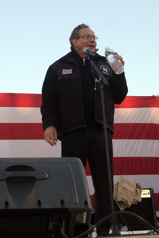 Comedian Lewis Black tells a joke to service members, including Marines and sailors with Regimental Combat Team 5, aboard Al Asad Air Base, Iraq, Dec. 19.  Black and several other performers, including Kid Rock, are spending their holidays performing shows for service members deployed overseas as part of a USO tour.::r::::n::