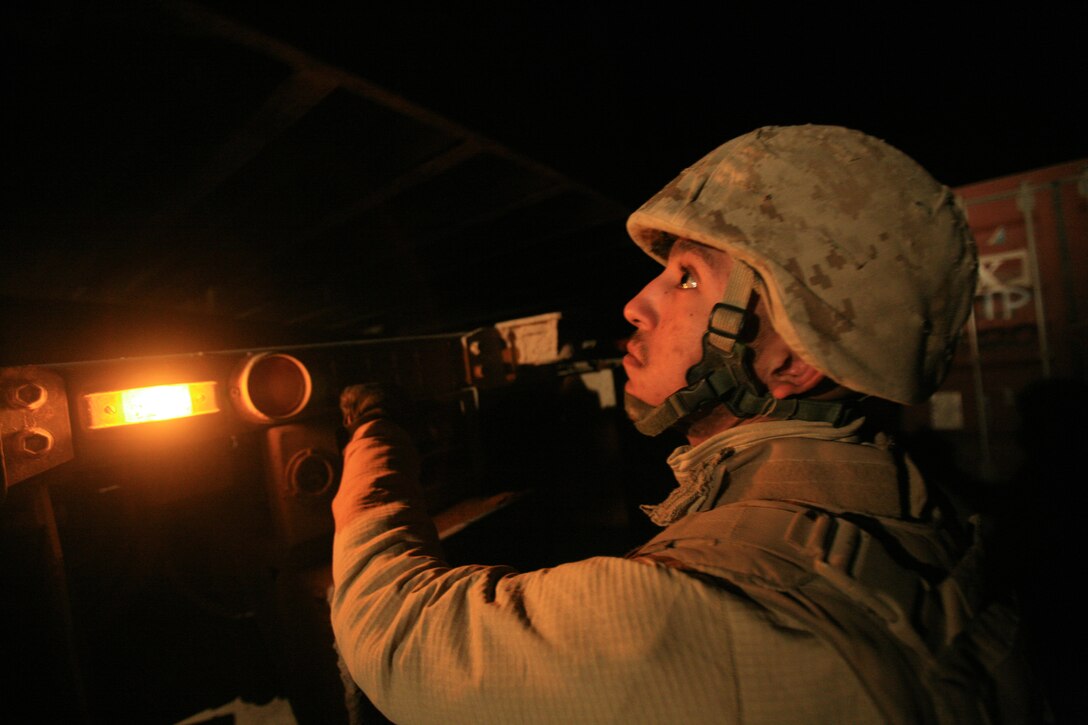 Lance Cpl. Marcel V. Campos, 20, from Long Beach, Calif., a Logistic Vehicle System operator with Motor Transportation Company, Combat Logistics Battalion 5, 1st Marine Logistics Group, operates the LVS hydraulic systems during a combat logistics patrol here Dec. 19. Motor T. Co. delivered fuel, food and supplies to the Marines at Observation Post Viking while Security Co. escorted them along the route, ensuring them a safe passage to their destination.