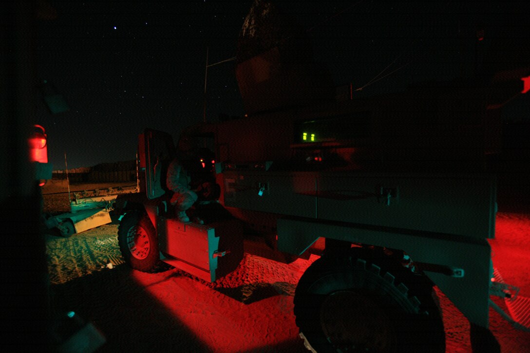 Cpl. Andrew C. Pauley, 20, from Monte Vista, Colo., a driver from 5th Squad, Security Company, Combat Logistics Battalion 5, 1st Marine Logistics Group, enters his Mine-Resistant, Armor-Protected vehicle after a test fire here Dec. 19. The Marines of Security Co. conduct a test fire of all their weapon systems prior to a mission to ensure they are operating correctly.
