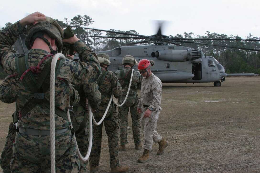 Marines with Weapons Company, Battalion Landing Team, 3rd Battalion, 2nd Marine Regiment, 22nd Marine Expeditionary Unit, participating in a Special Patrol Insertion/Extraction exercise, prepare their gear before a CH-53E Super Stallion helicopter from Marine Medium Tiltrotor Squadron 263 (Reinforced) takes off from a landing zone aboard Camp Lejeune, N.C., Dec. 19, 2008. (Official Marine Corps photo by Lance Cpl. Alicia R. Giron)