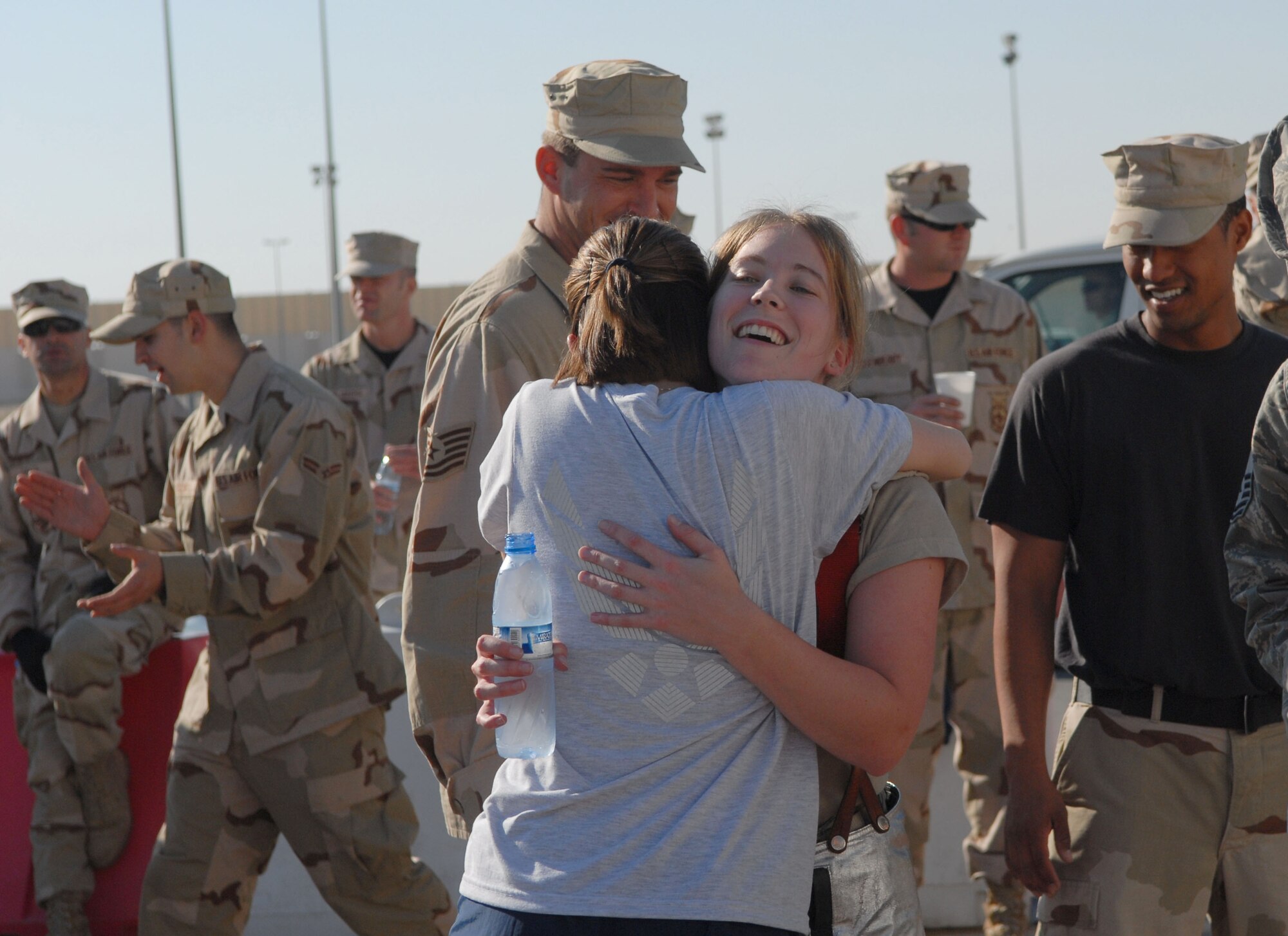 SOUTHWEST ASIA -- Airman 1st class Amanda Boehne, 380th Expeditionary Force Support Squadron, gets a congratulatory hug after completing the Firefighter Challenge here Dec. 20. The 380th Expeditionary Civil Engineer Fire and Emergency Services Flight hosted the event to provide insight on the mental and physical challenges firefighters face in daily training and emergency responses. Airman Boehne, an Air National Guard member who calls Waconia, Minn., home, is deployed from the 133rd Airlift Wing in Minneapolis, Minn. (U.S. Air Force photo by Tech. Sgt. Denise Johnson) (released)