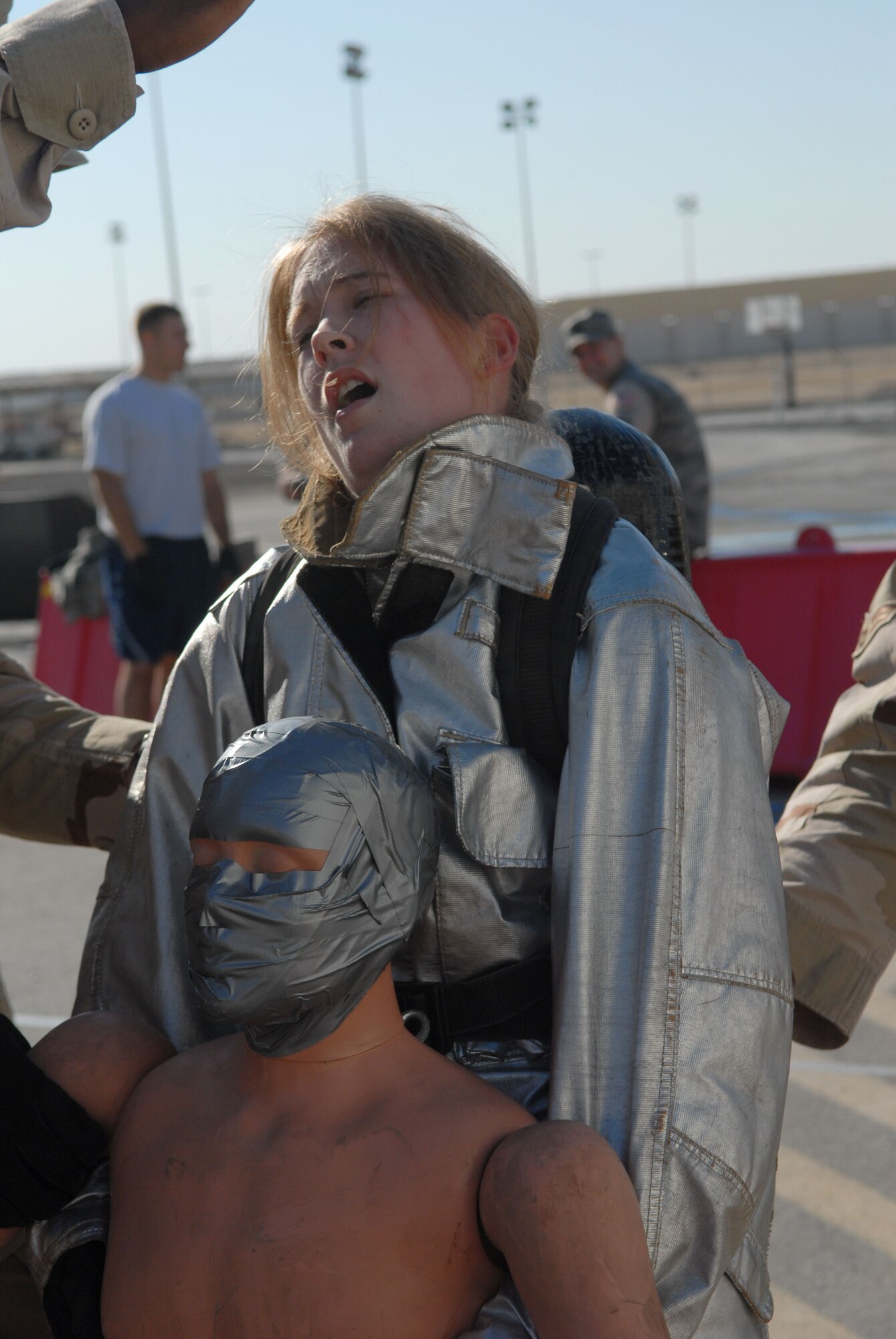 SOUTHWEST ASIA -- Airman 1st class Amanda Boehne, 380th Expeditionary Force Support Squadron, carries a mannequin weighing about 100 pounds in the Firefighter Challenge here Dec. 20. The 380th Expeditionary Civil Engineer Fire and Emergency Services Flight hosted the event to provide insight on the mental and physical challenges firefighters face in daily training and emergency responses. Airman Boehne, an Air National Guard member who calls Waconia, Minn., home, is deployed from the 133rd Airlift Wing, Minneapolis, Minn. (U.S. Air Force photo by Tech. Sgt. Denise Johnson) (released)